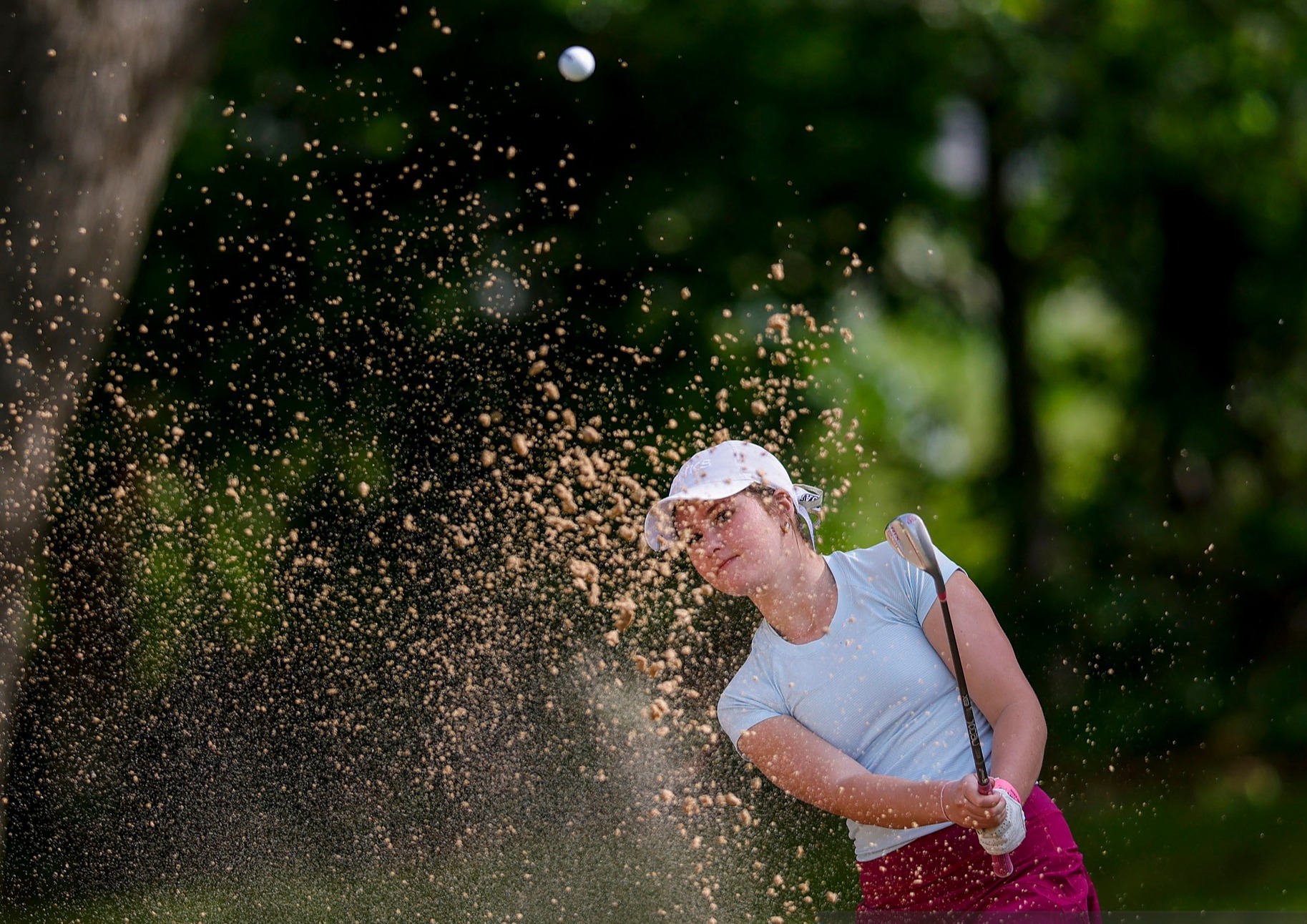 girl hitting golf ball