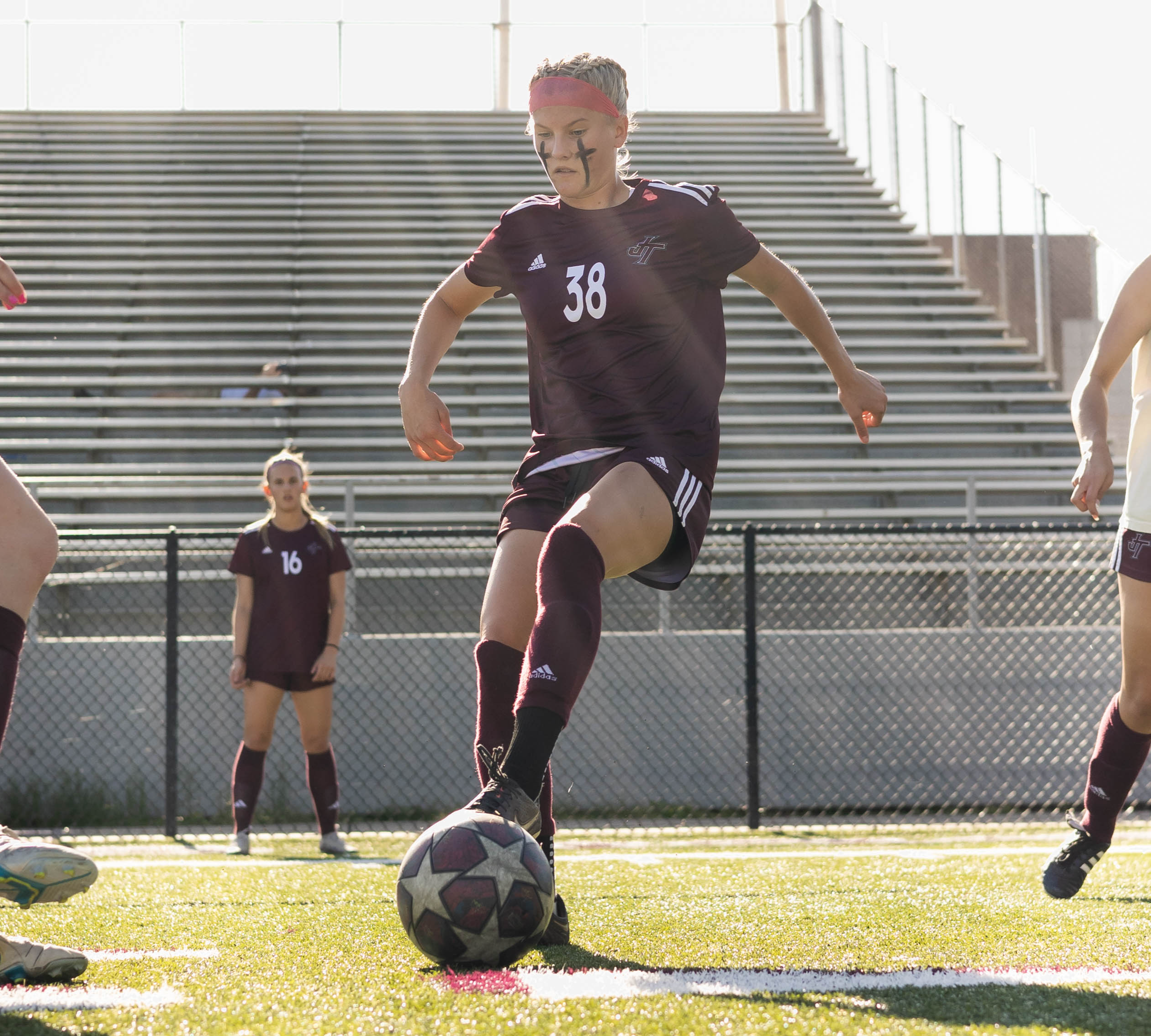 girl kicking soccer ball