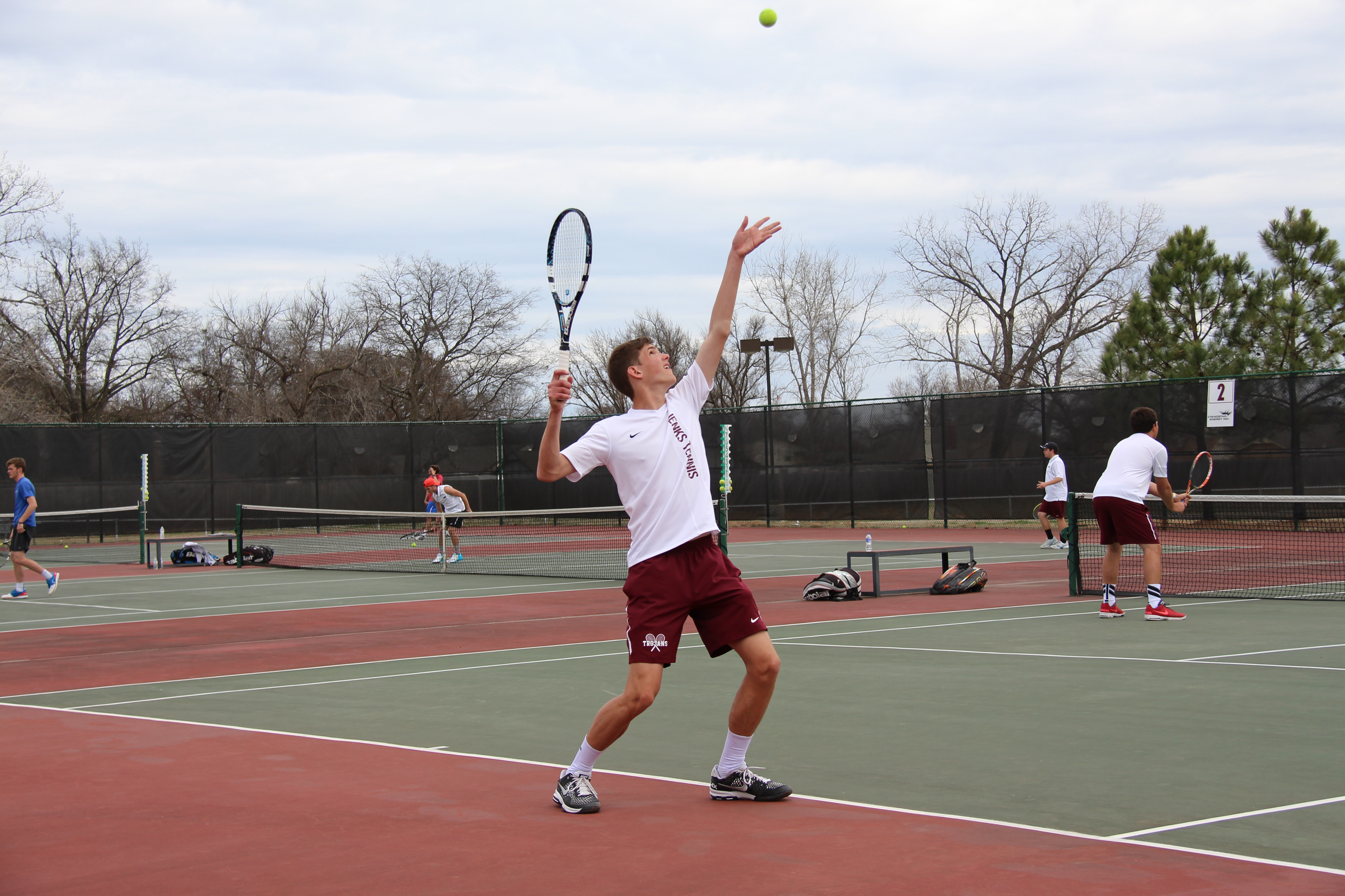 boy hitting tennis ball