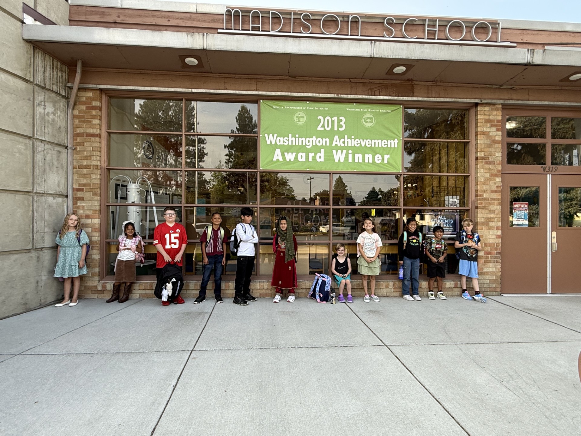 Madison students standing in front of the school on the first day of school for the 2025-26 school year
