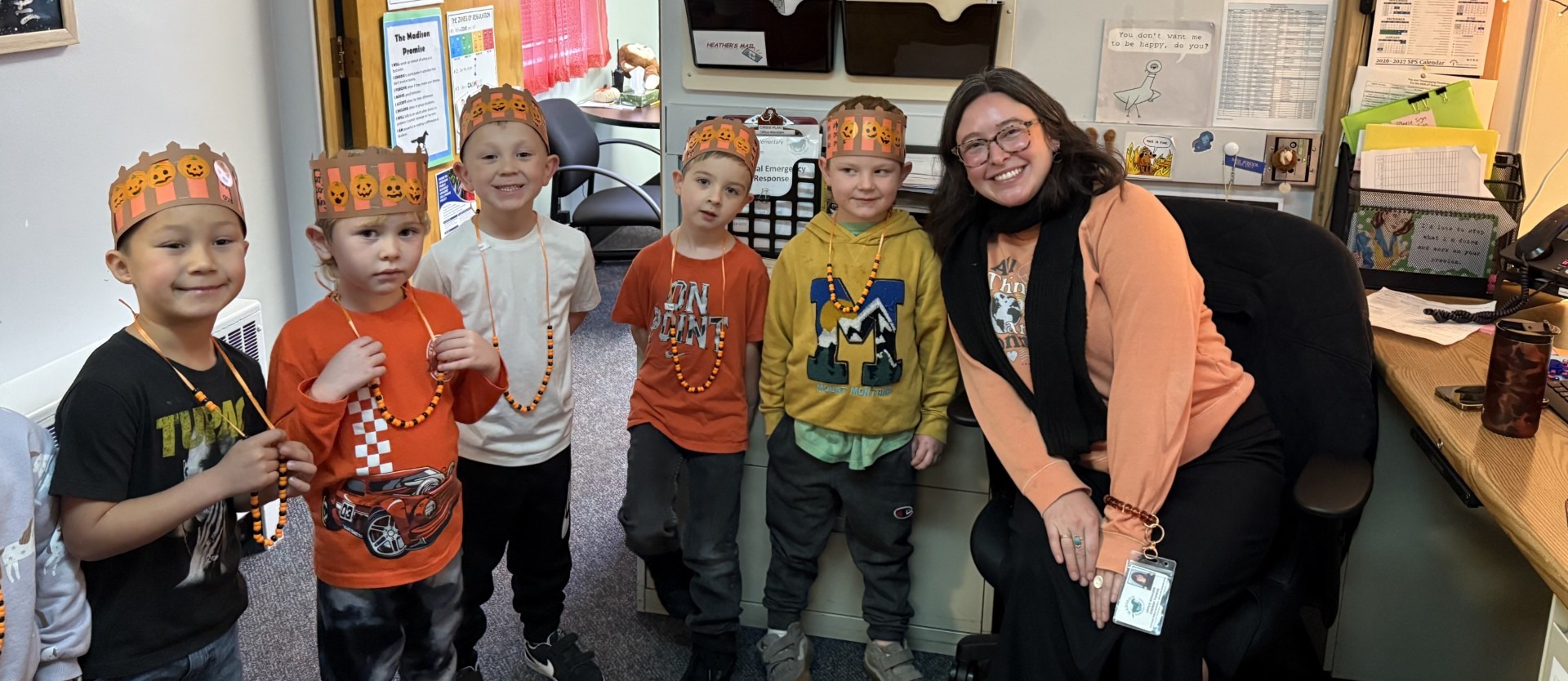 Kindergarten students wear pumpkin crowns in the Madison office.