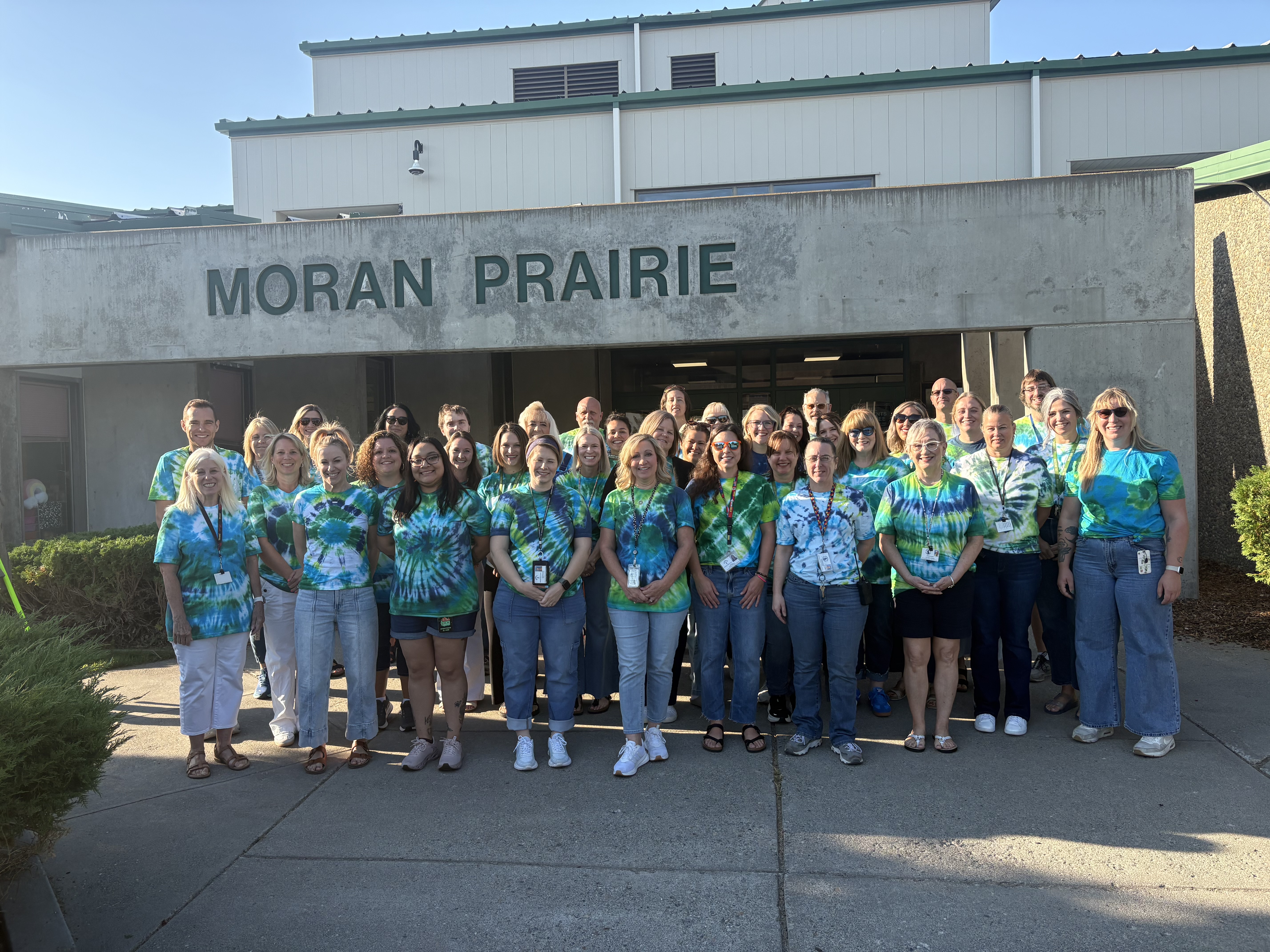 Staff group photo in tie-dye shirts