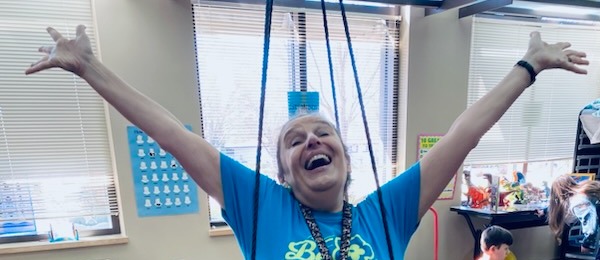 Woman on a swing with her arms stretched wide