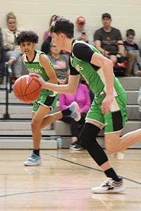 Two students playing basketball 