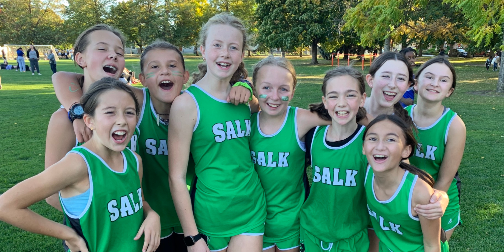 6th grade cross country girls smiling at camera