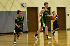 dribbling the basketball, others running down court