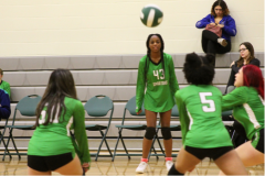 volleyball in the air with team around