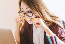 student looking at something, probably school homework, worried