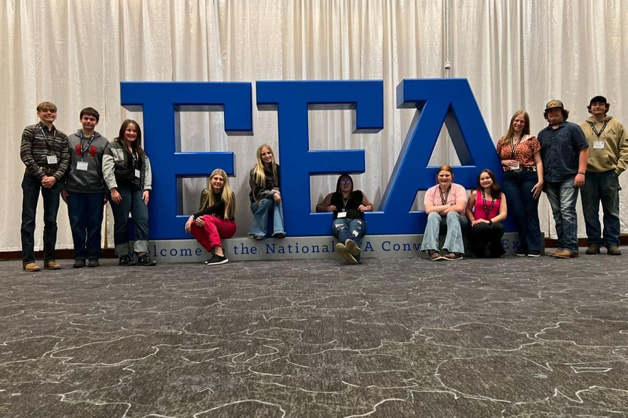 students pictured in front of large ffa letters at national convention