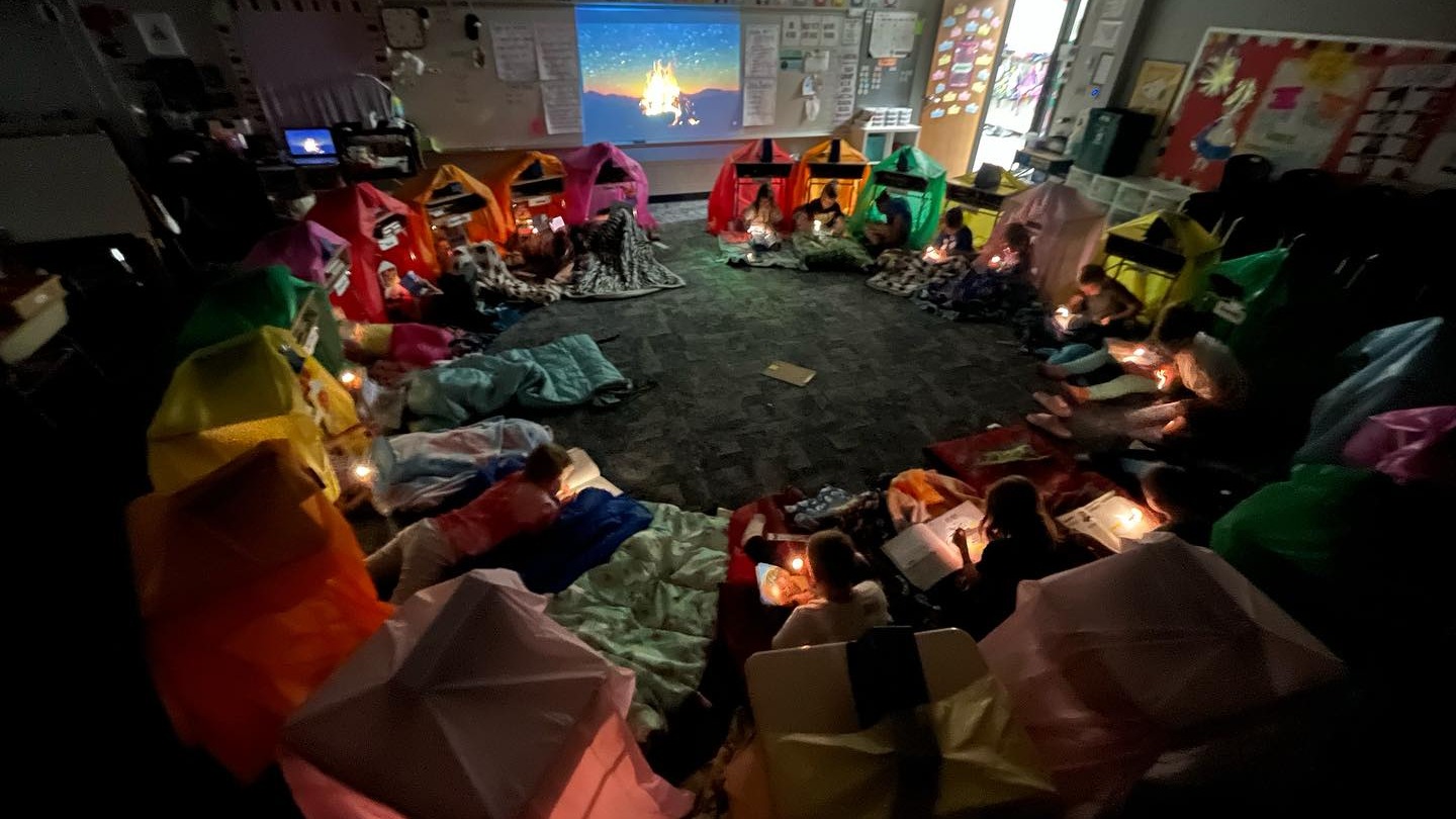 3nd grade students in circle under "camping tents" in classroom