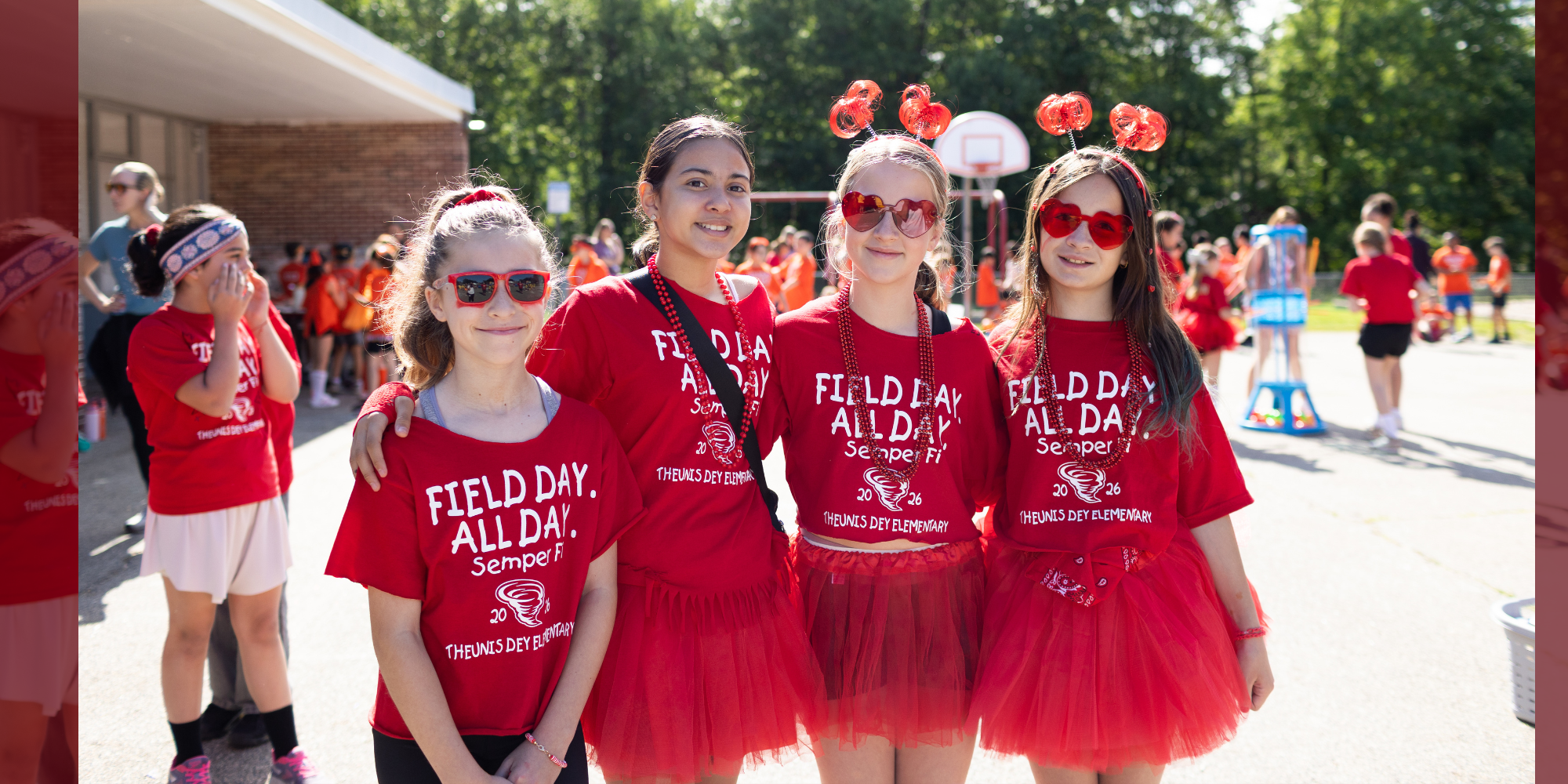 Four girls in red tutus pose for a photo, each wearing matching shirts with "Field Day All Day" and other text.