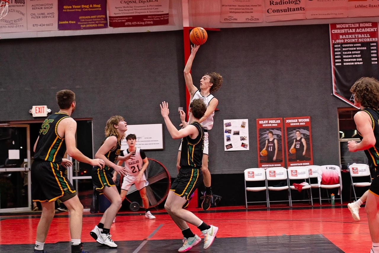 boy shooting a basket