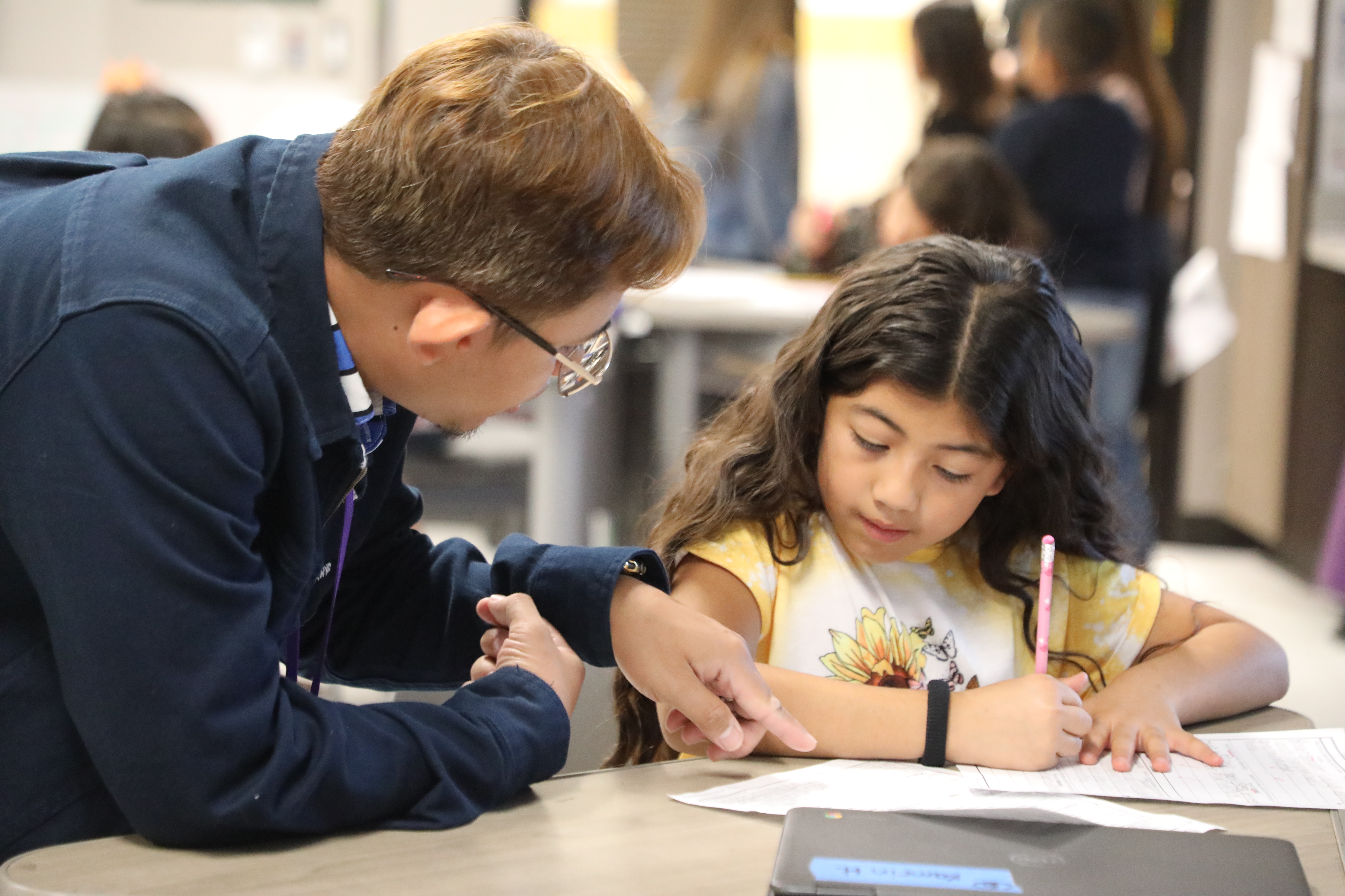 teacher assisting student