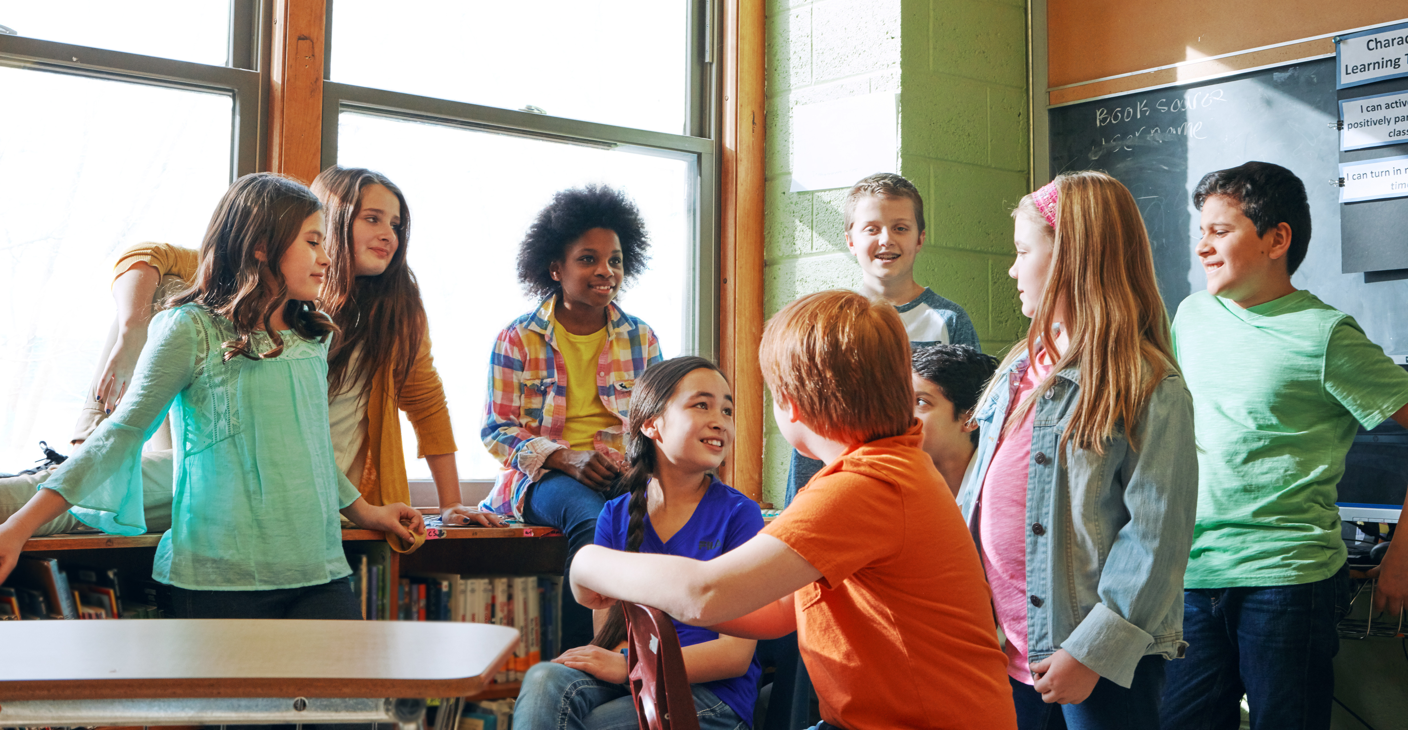 Students gathered around a teacher in a classroom