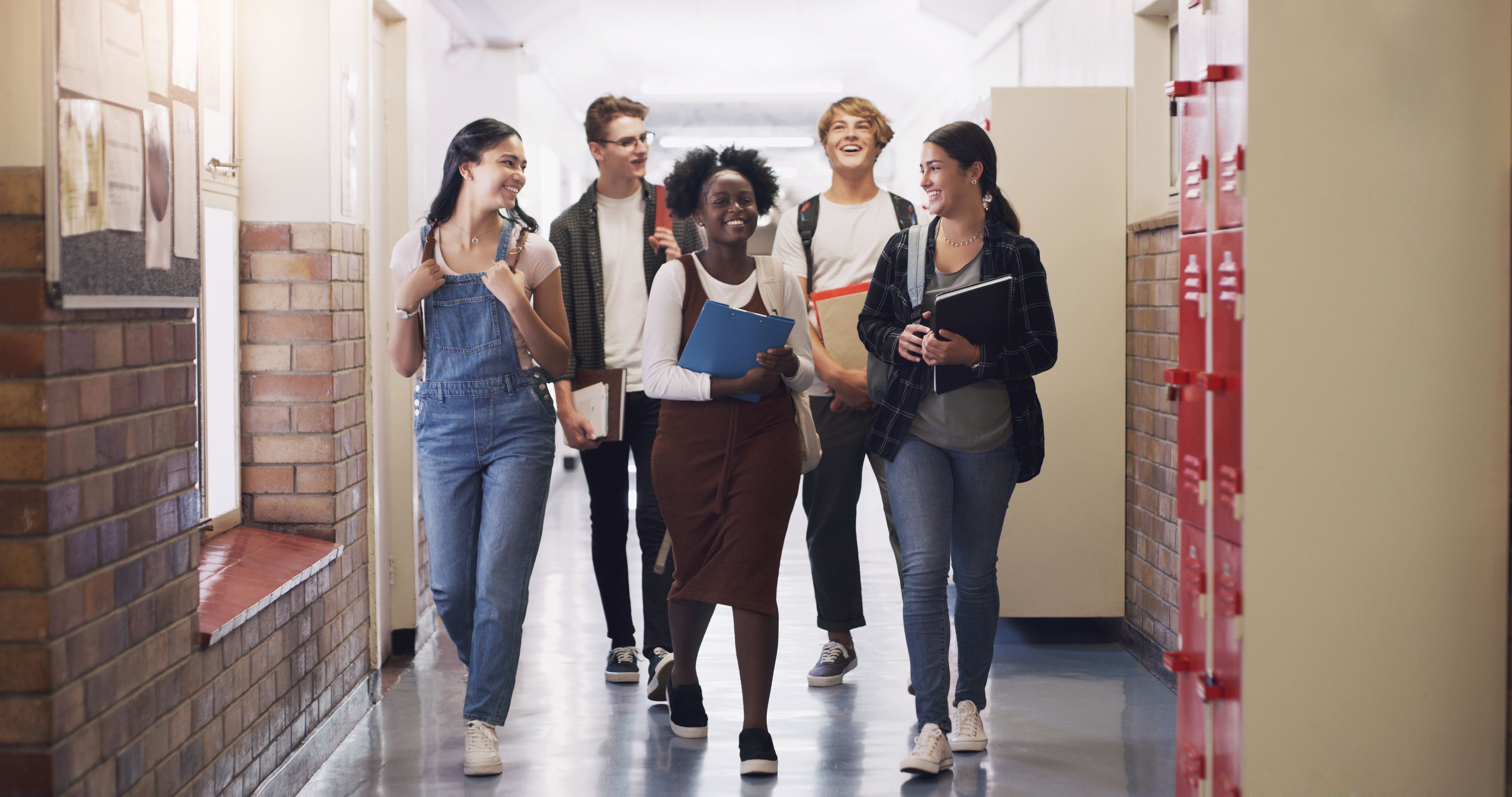 A group of high-school aged students in a school hallway