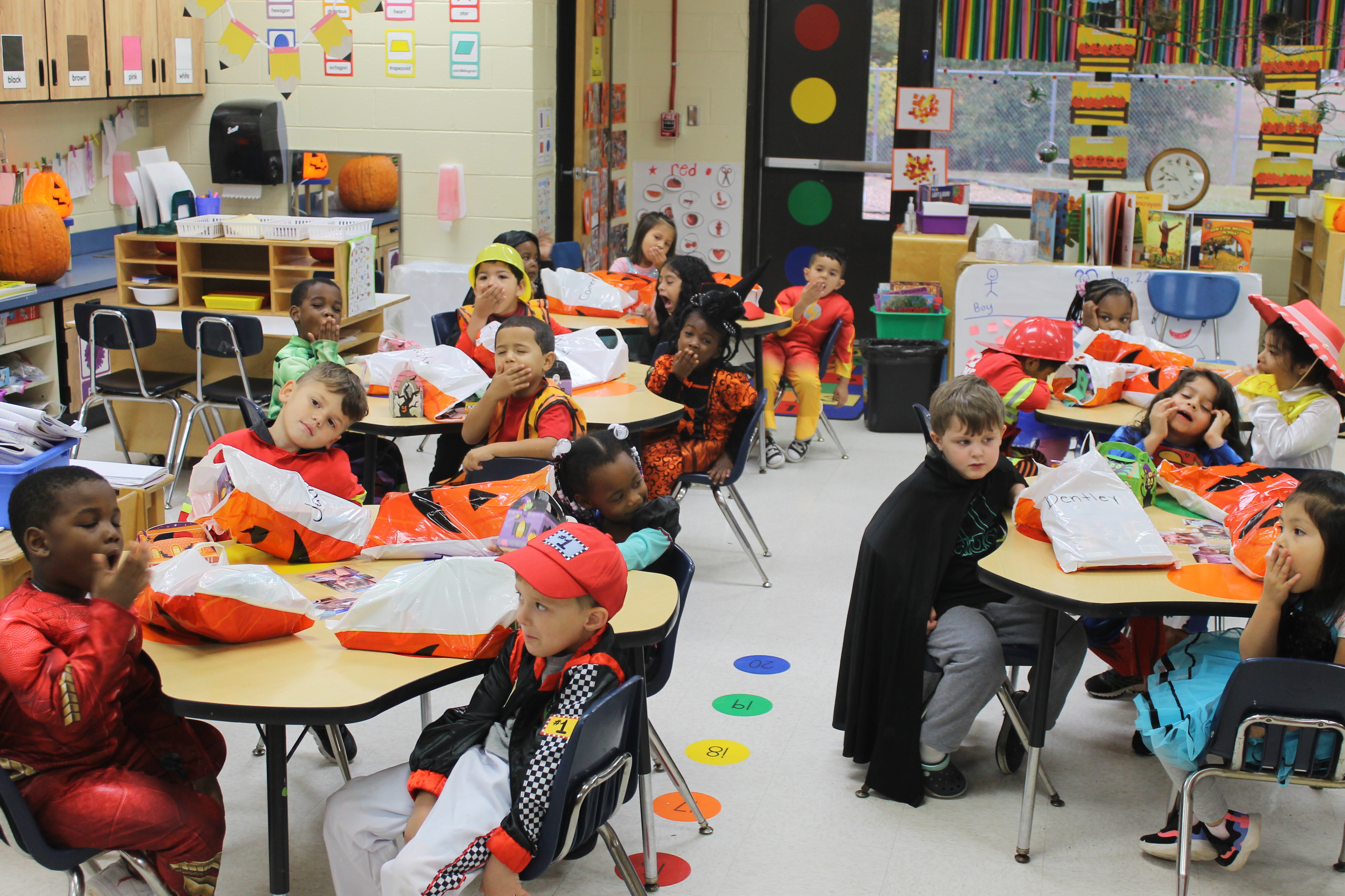 students sitting at tables in halloween costumes