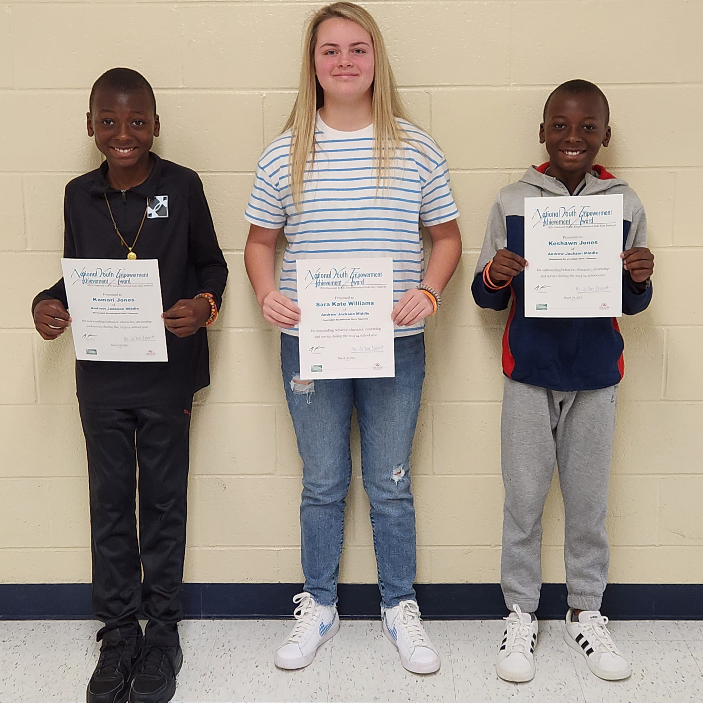 Three students holding certificates for National Youth Empowerment Achievement awards