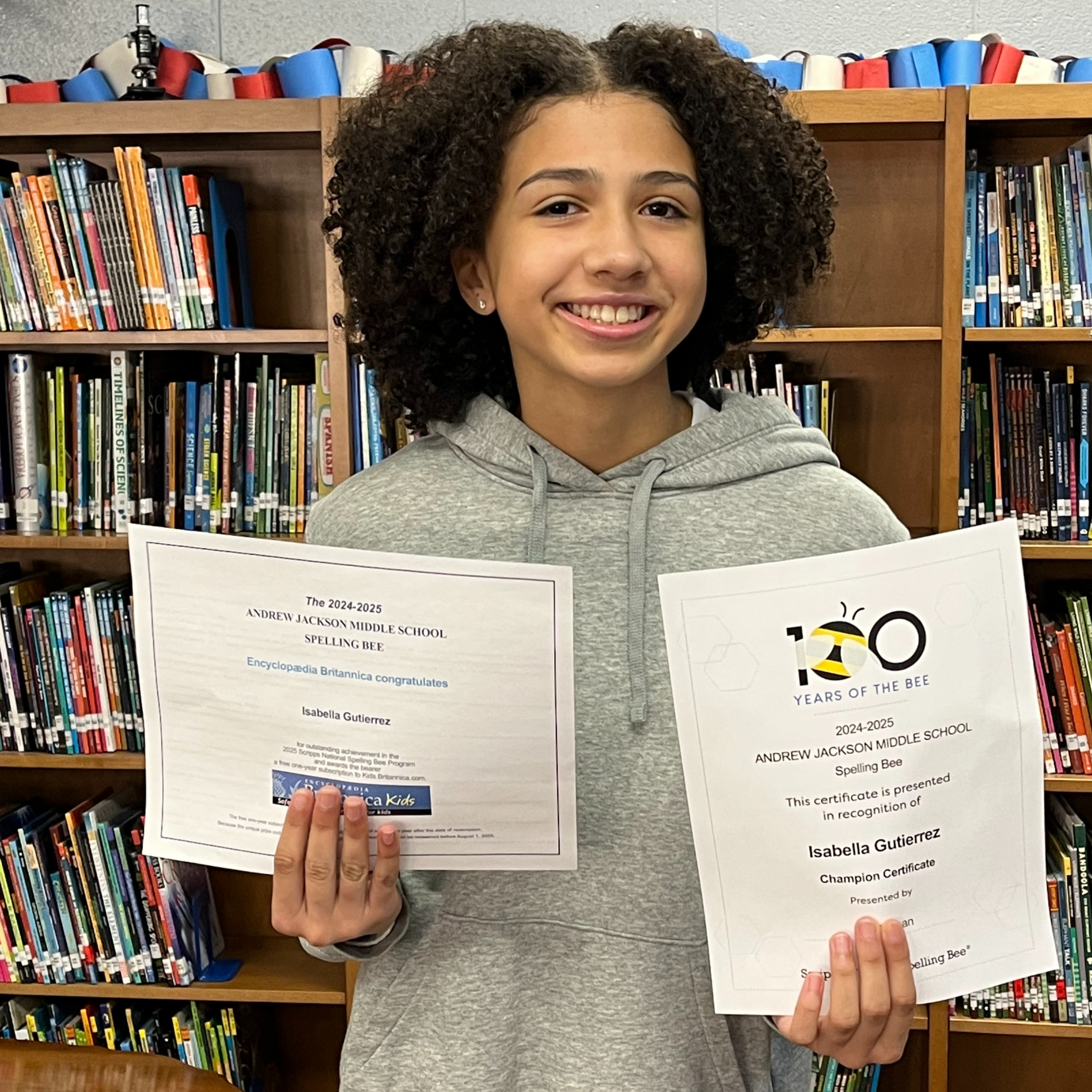 image of spelling bee winner holding certificate