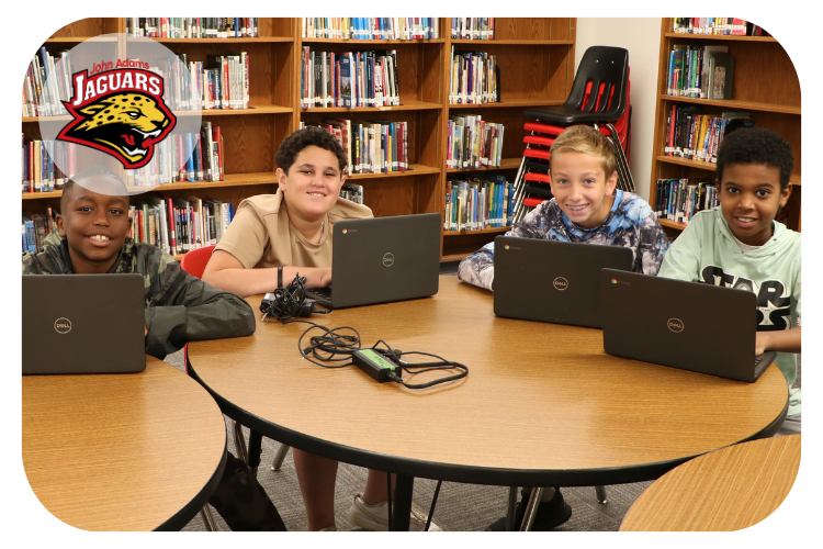 john adams students working on their chromebooks in the library.