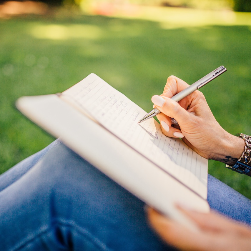 image of person writing outside