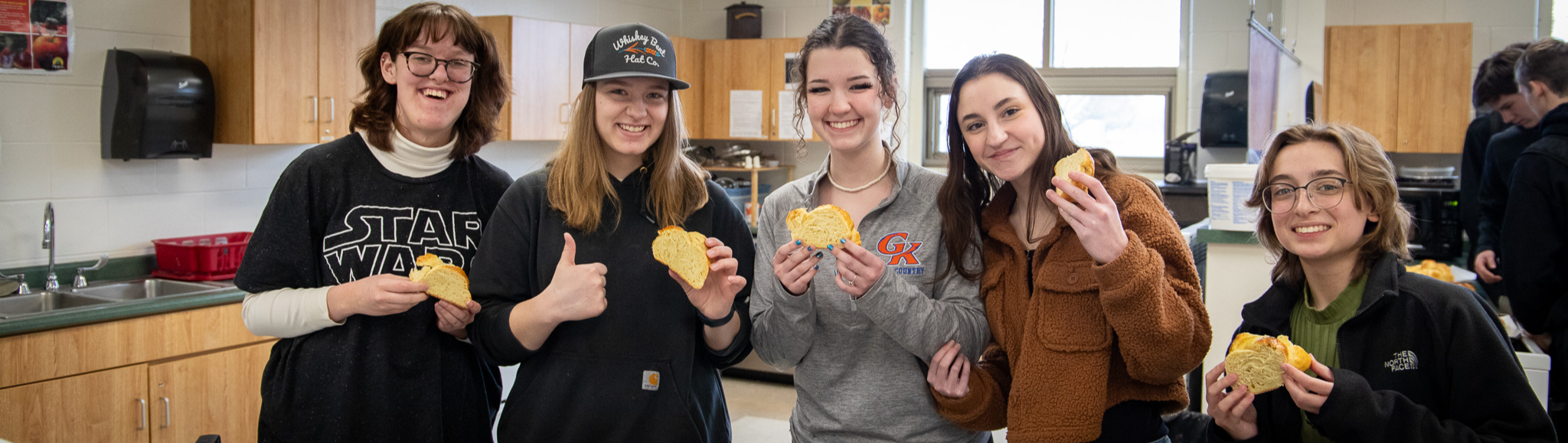 image of students enjoying Challah bread they made