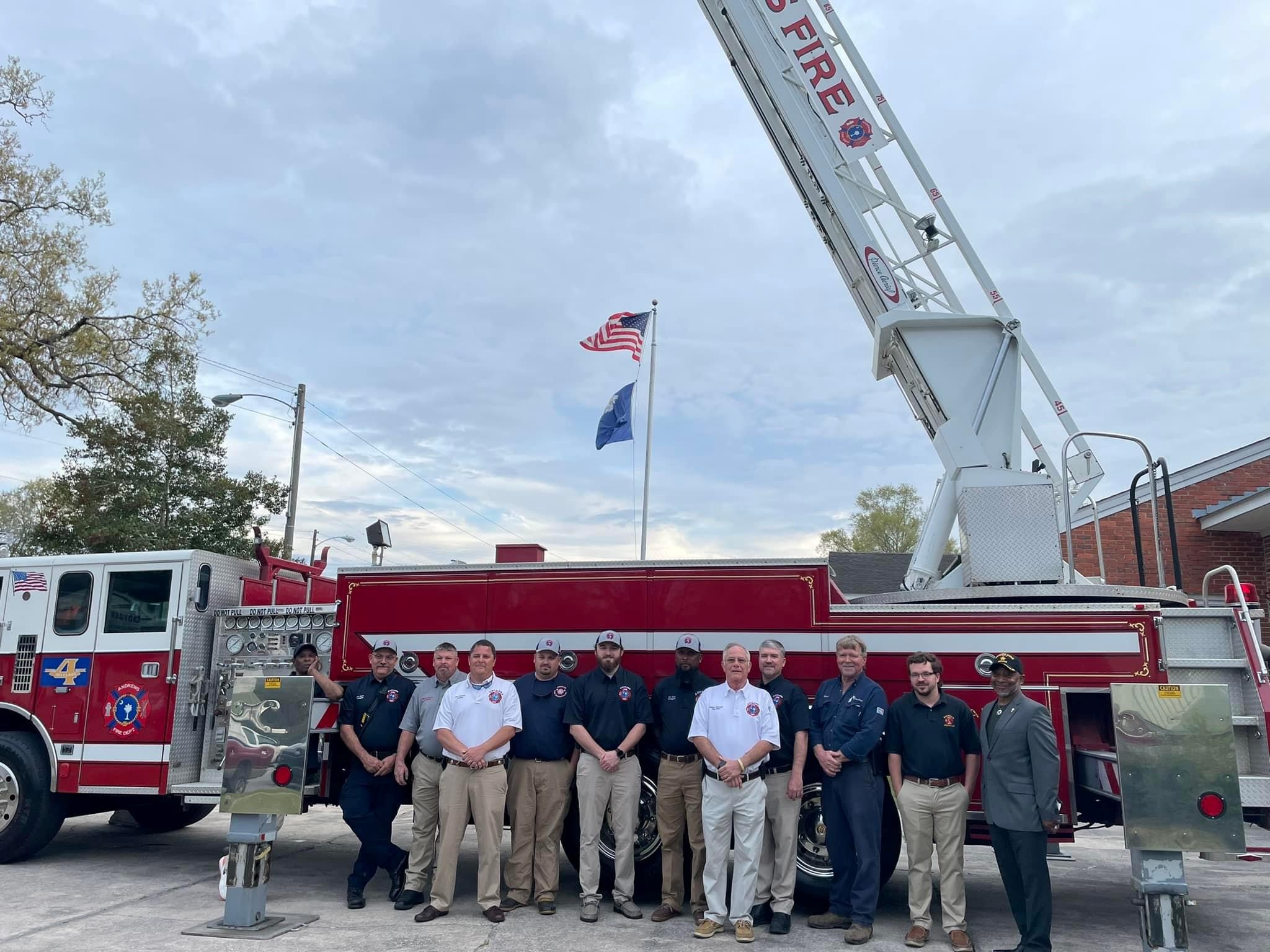 Andrews Fire Department Volunteers standing in front of ladder truck with the Mayor