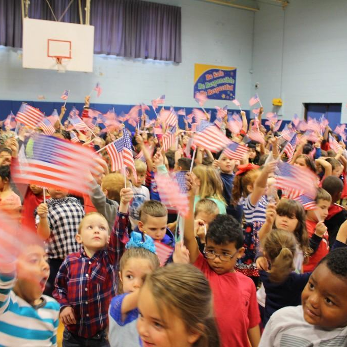 kids waving American flag
