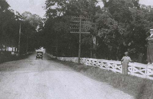 black and white road with white fence Lend the City Historic Photos, Documents