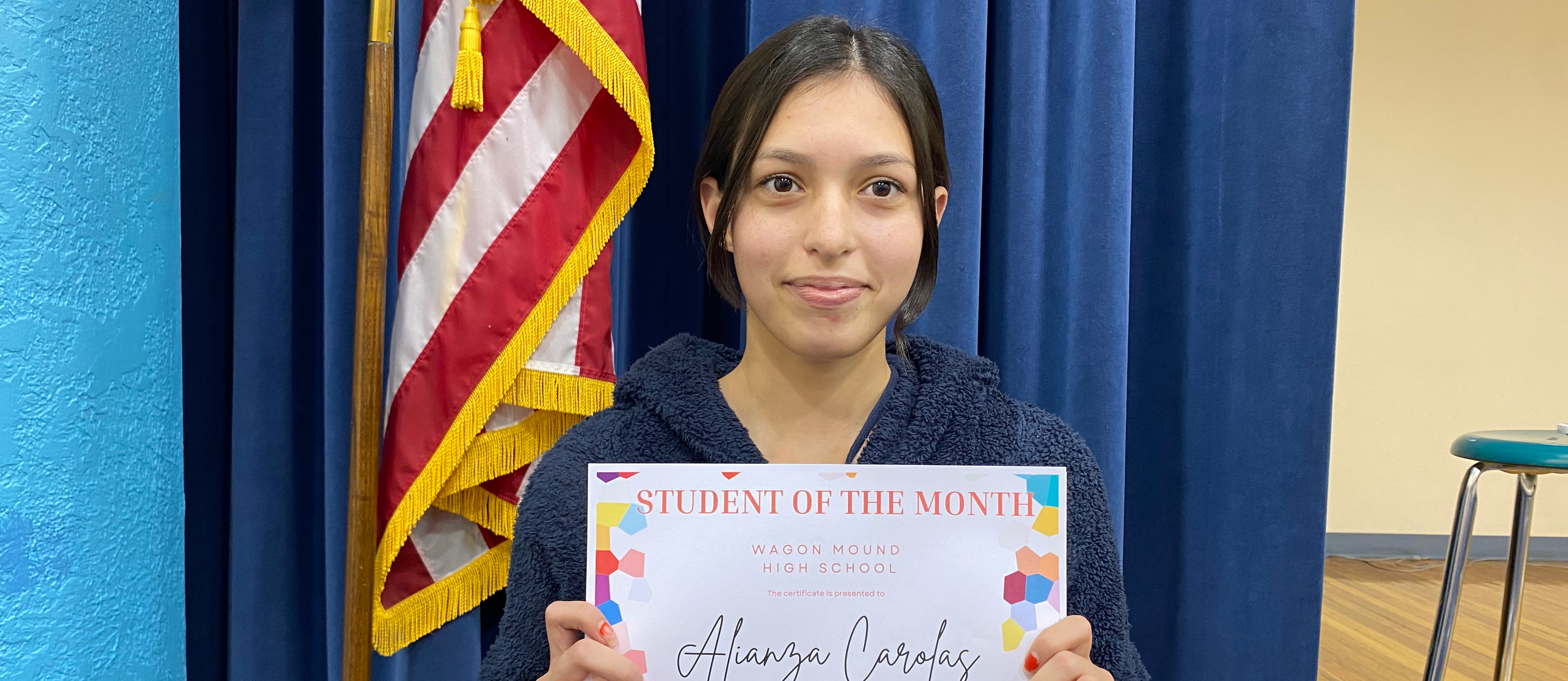 HS Student of the Month holding certificate