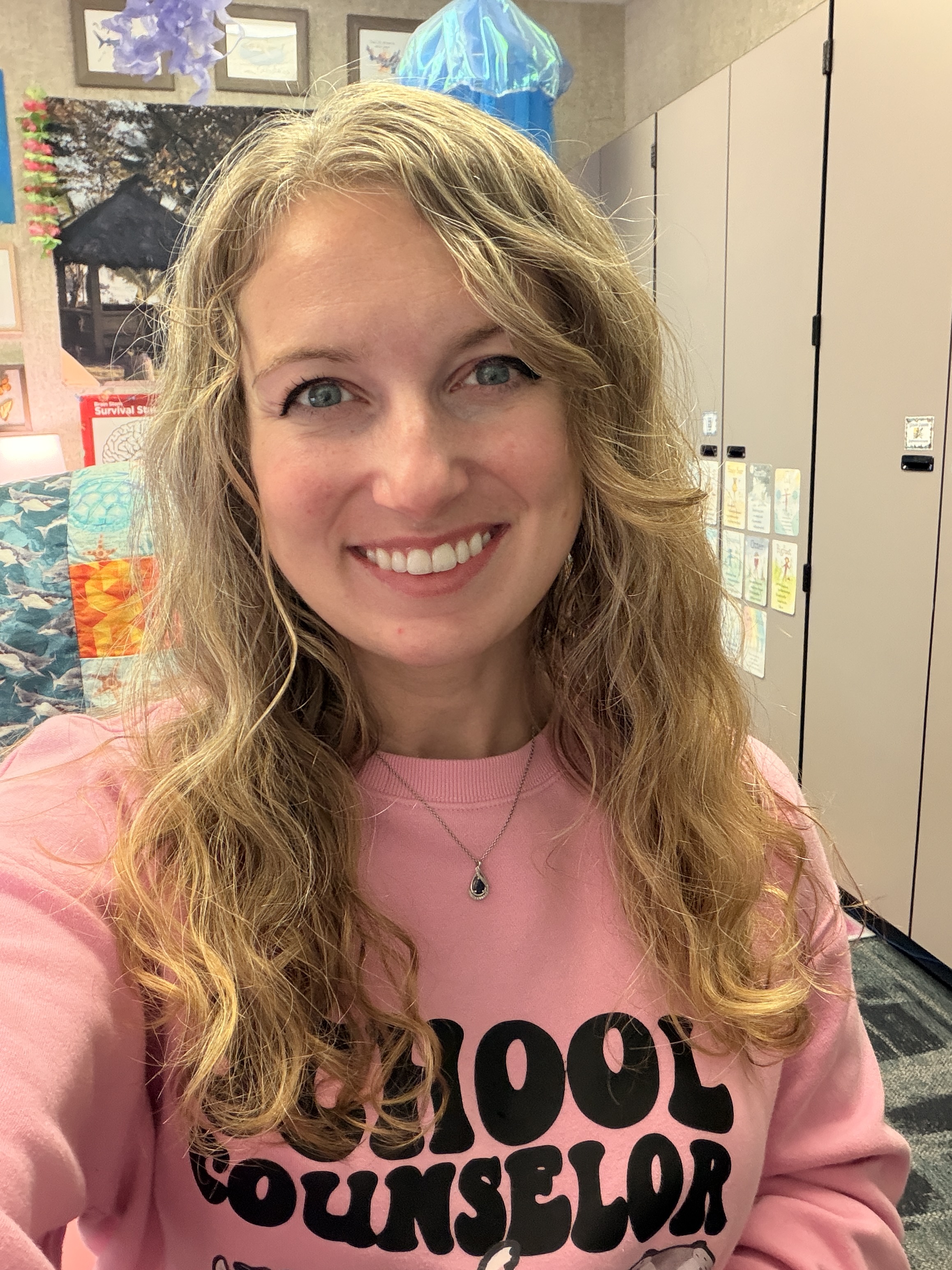 shoulders up photo of FES school counselor in a pink sweater