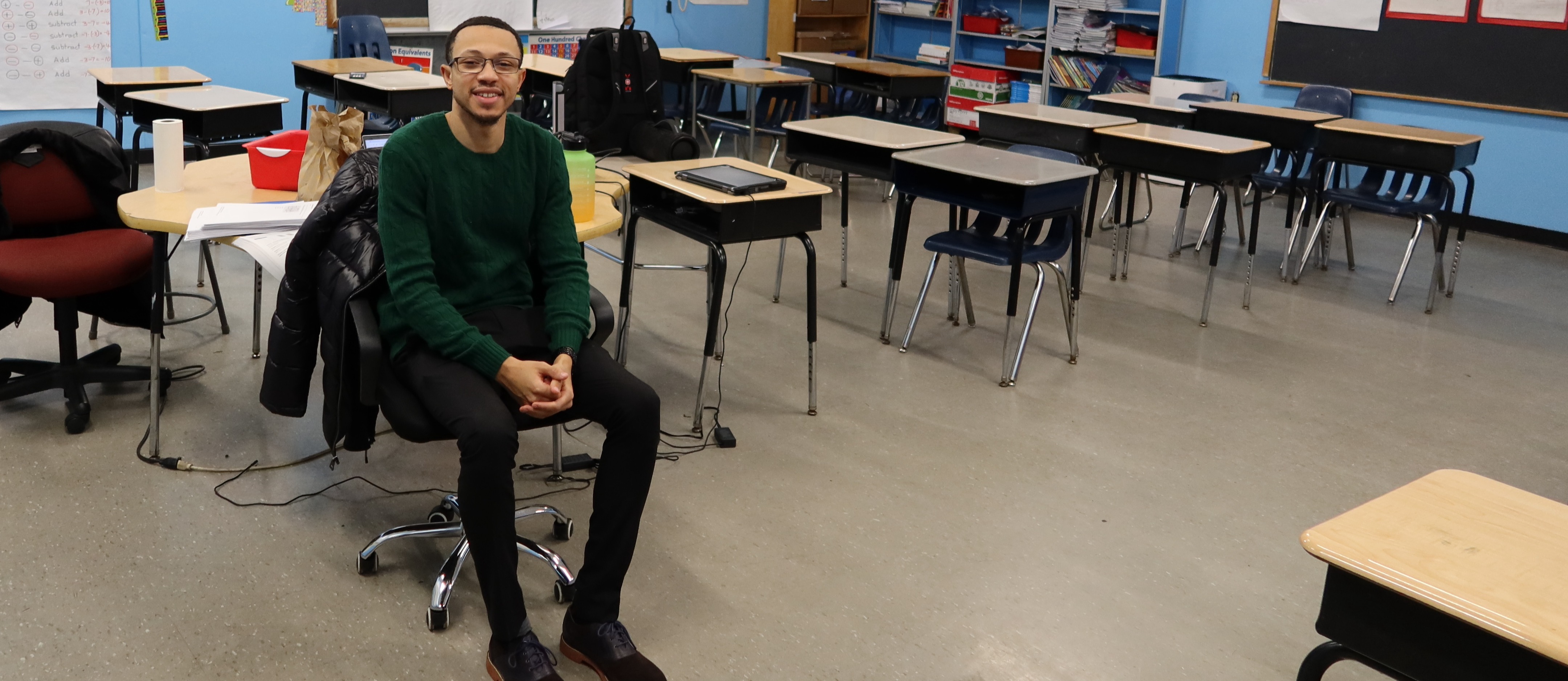 Mr. White poses for picture in his classroom.