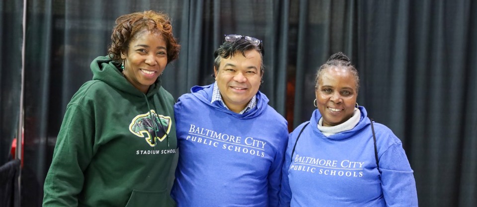 three employees smiling