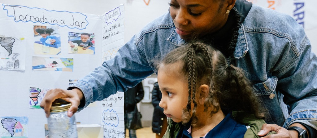 teacher showing an experiment to a student