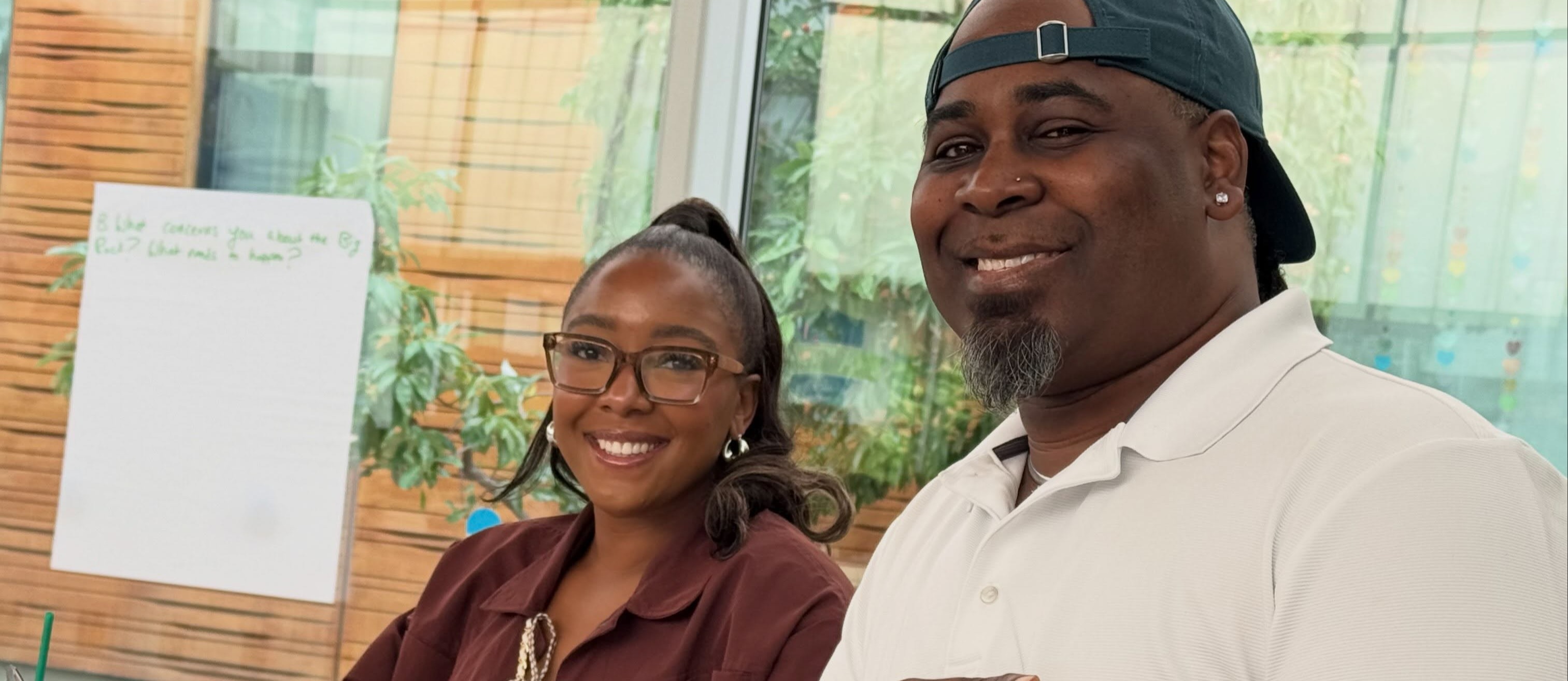 Two employees sitting at a table smiling