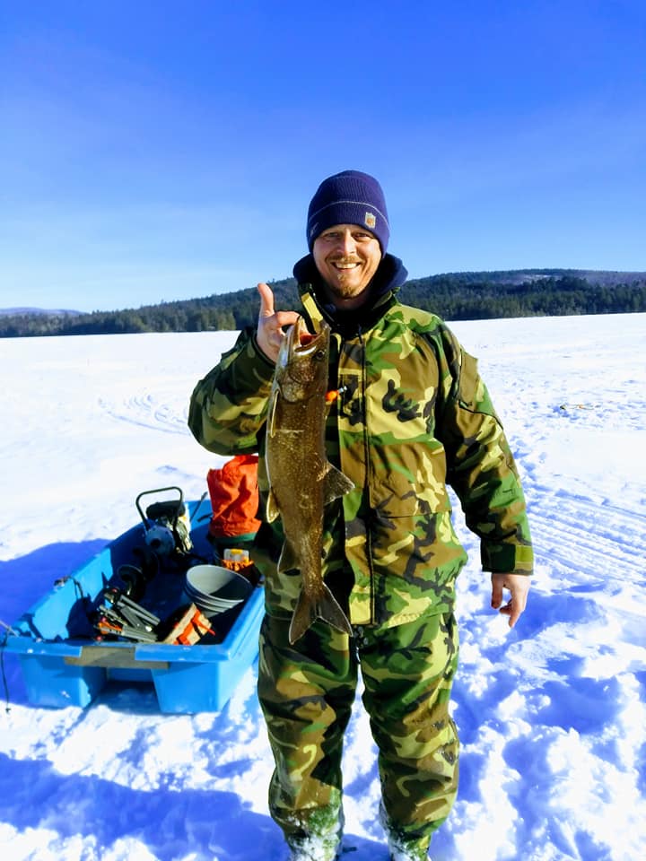 man dressed up in camo holding a thumbs up