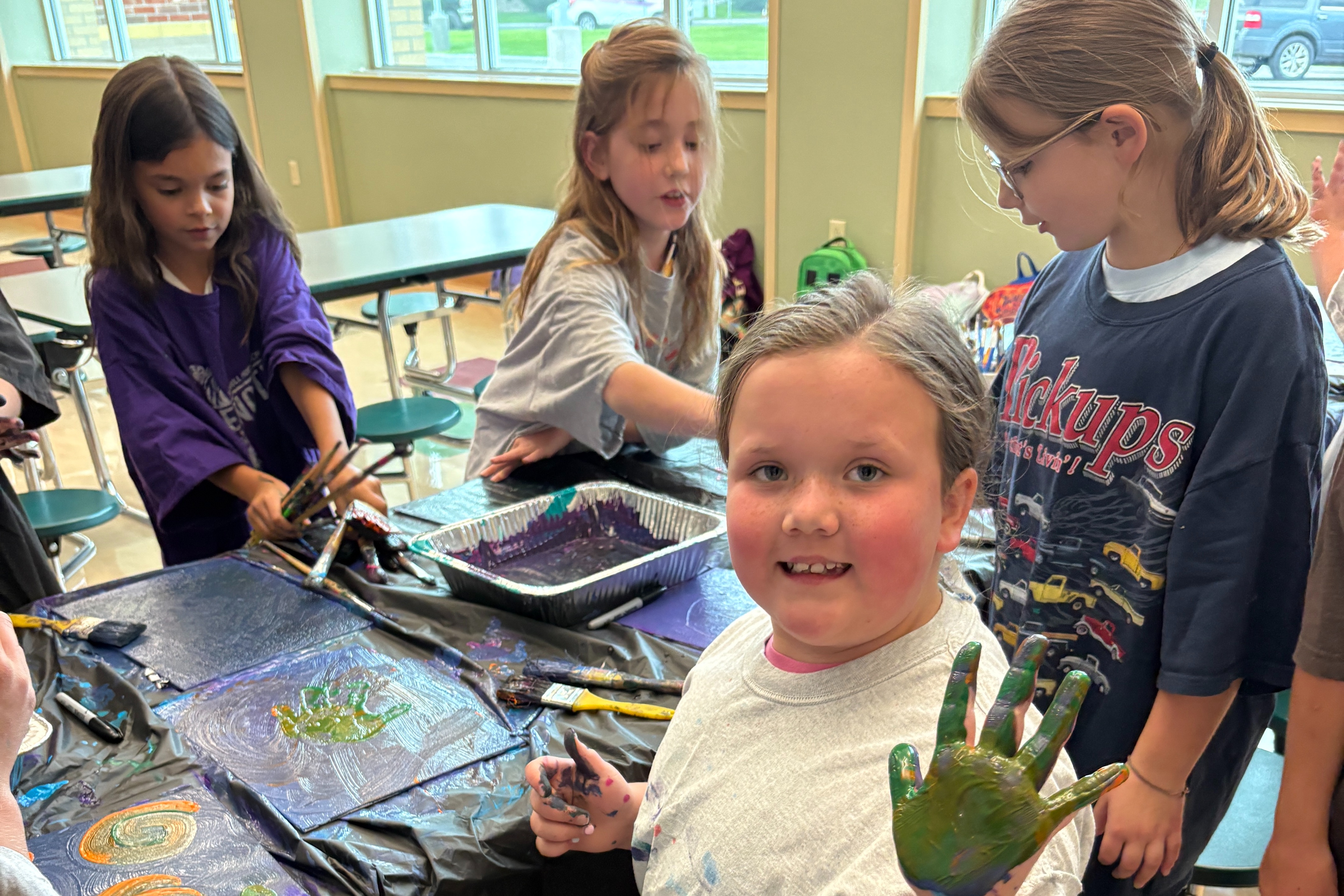 Kids in Art Club with paint on their hands