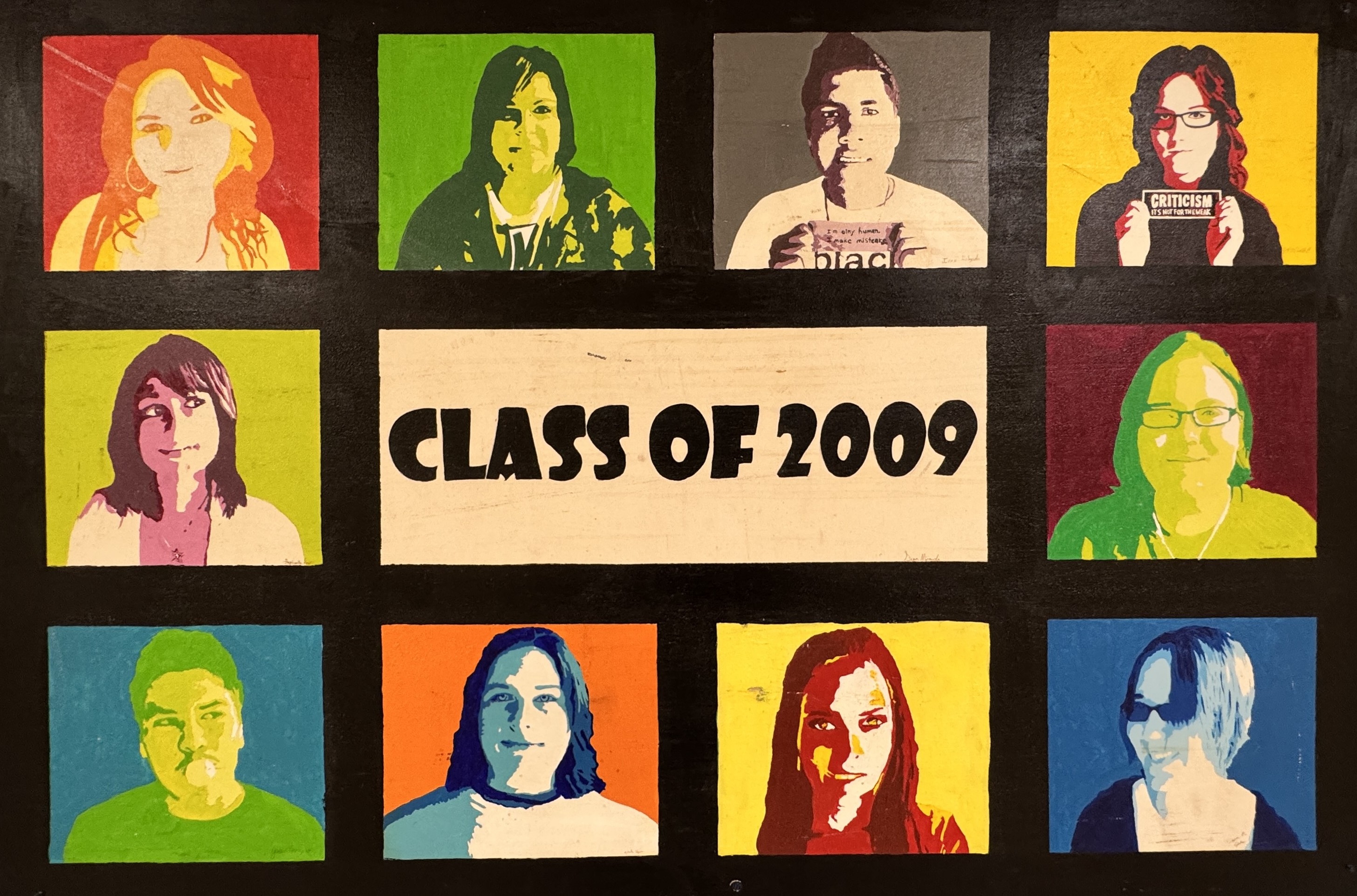 A mural featuring a grid of twelve colorful, pop-art-style portraits of students, each in a different bright color scheme. The center of the mural has a beige rectangle with bold black text that reads "CLASS OF 2009." Each student portrait is framed in a vibrant square with a contrasting background, giving the mural a Warhol-inspired, artistic look.