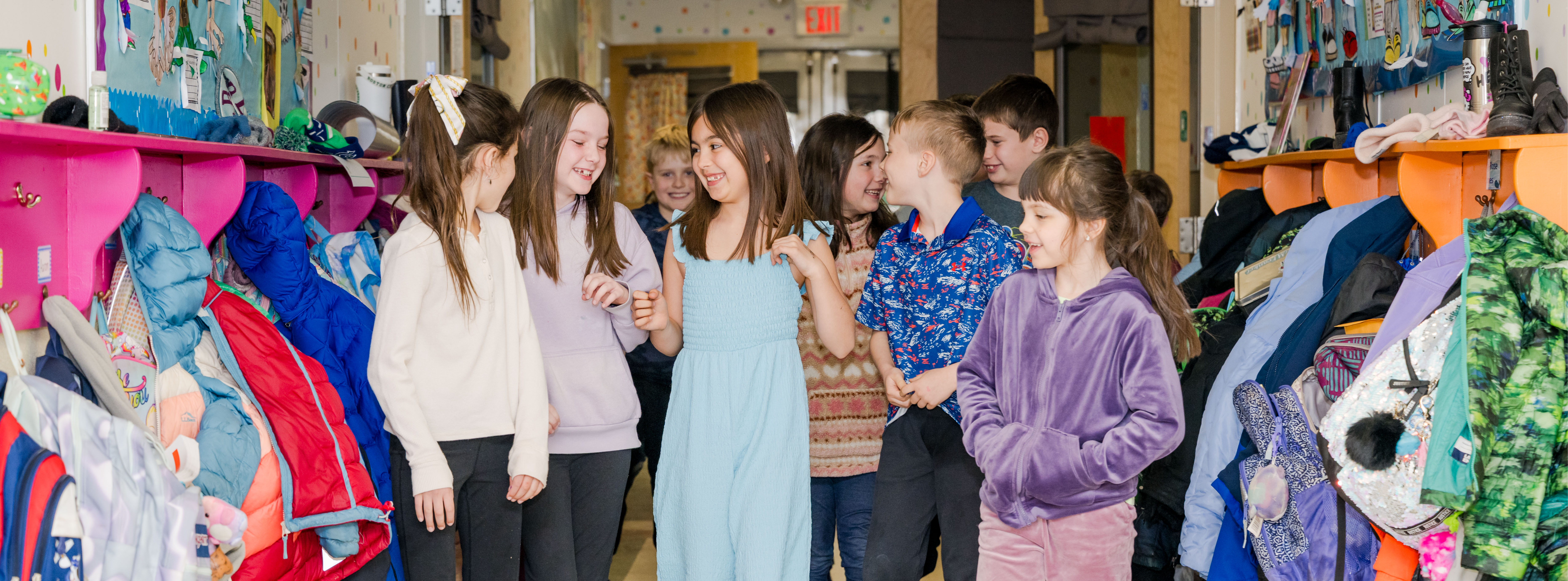 girls walking in hallway together laughing