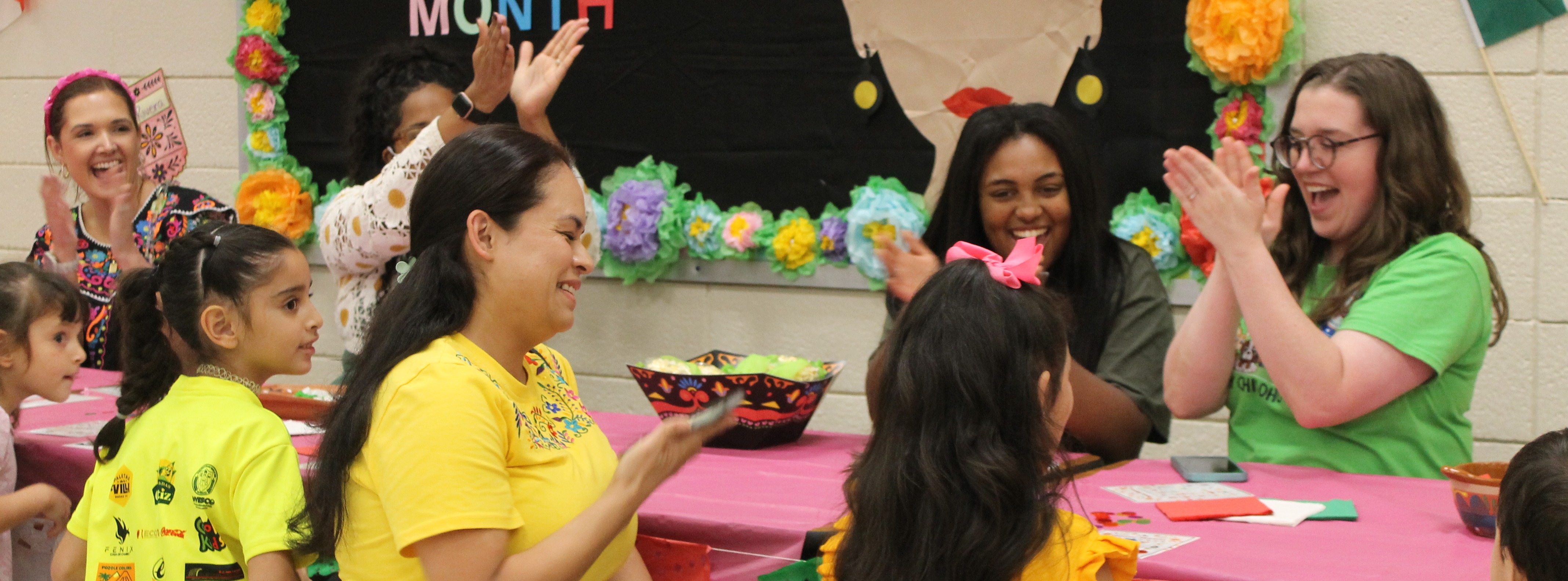 ECC families and staff celebrate a bingo win at Hispanic Heritage Literacy Night