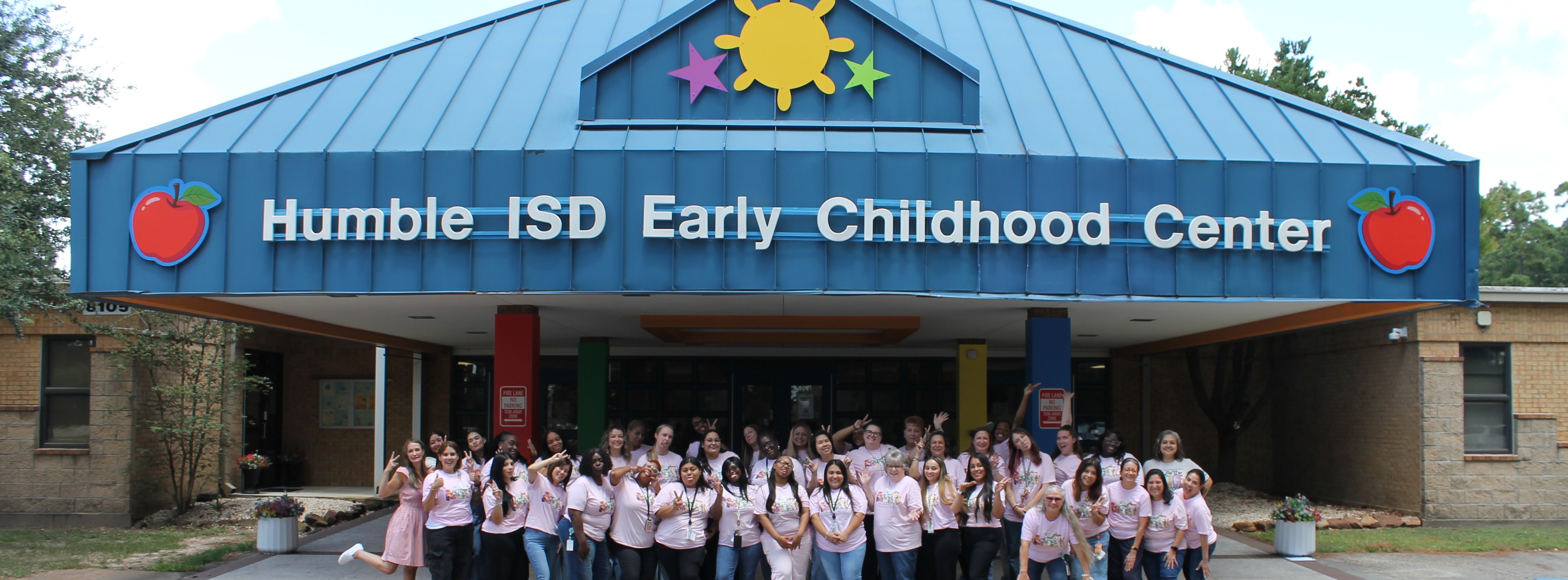 ECC staff poses outside the building