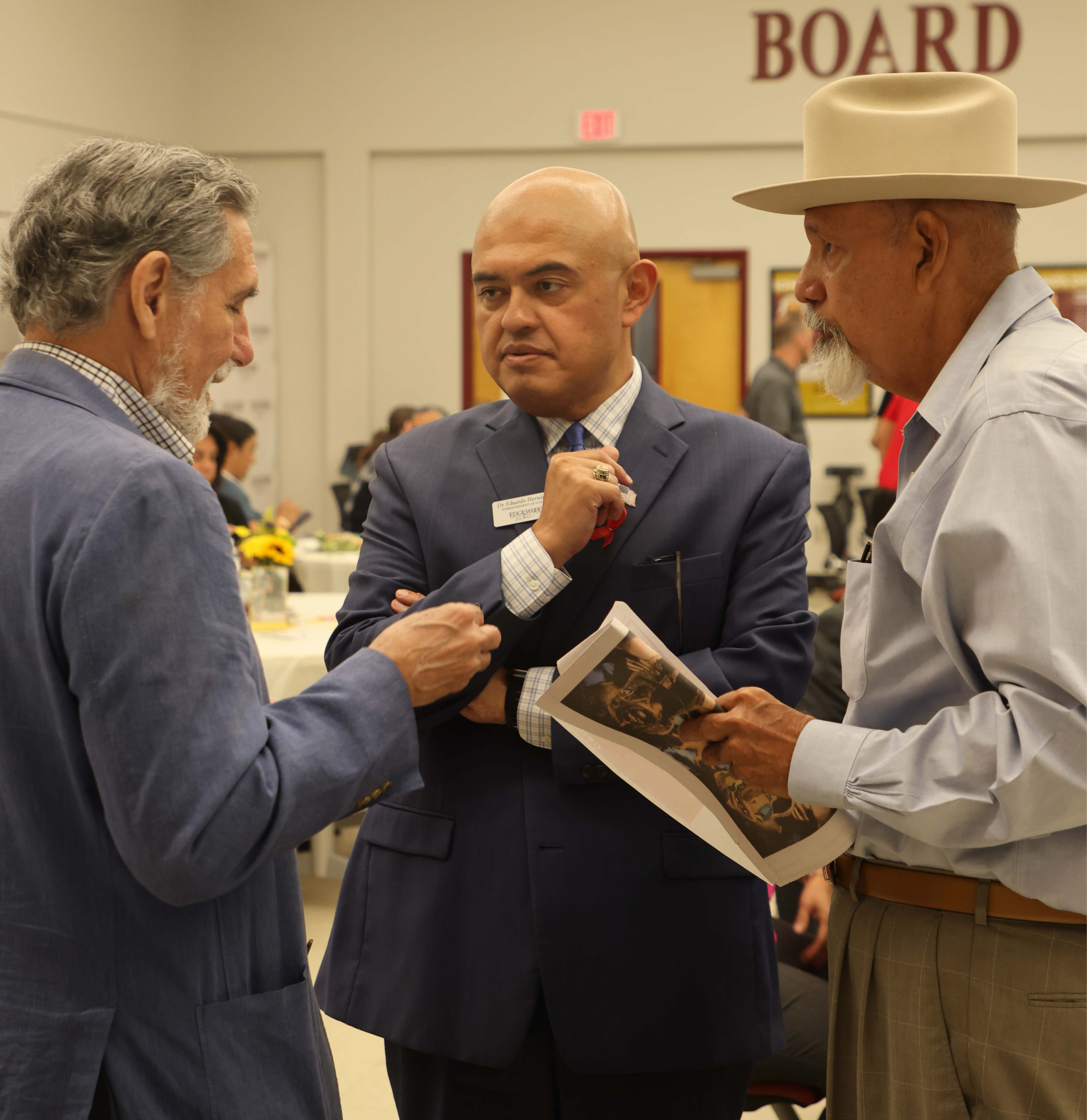 Dr. Hernandez speaks with two men who attended the Superintendent's Community Council