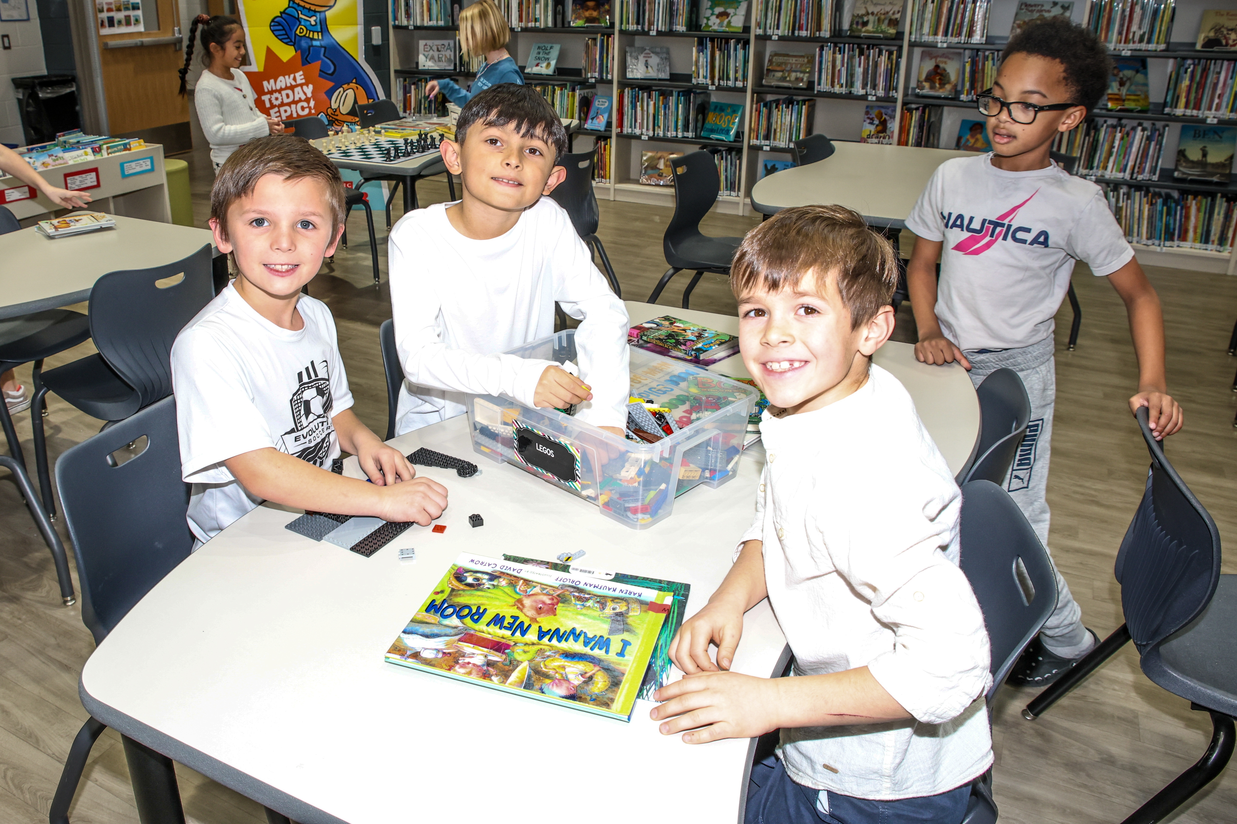 students smiling and standing in classroom