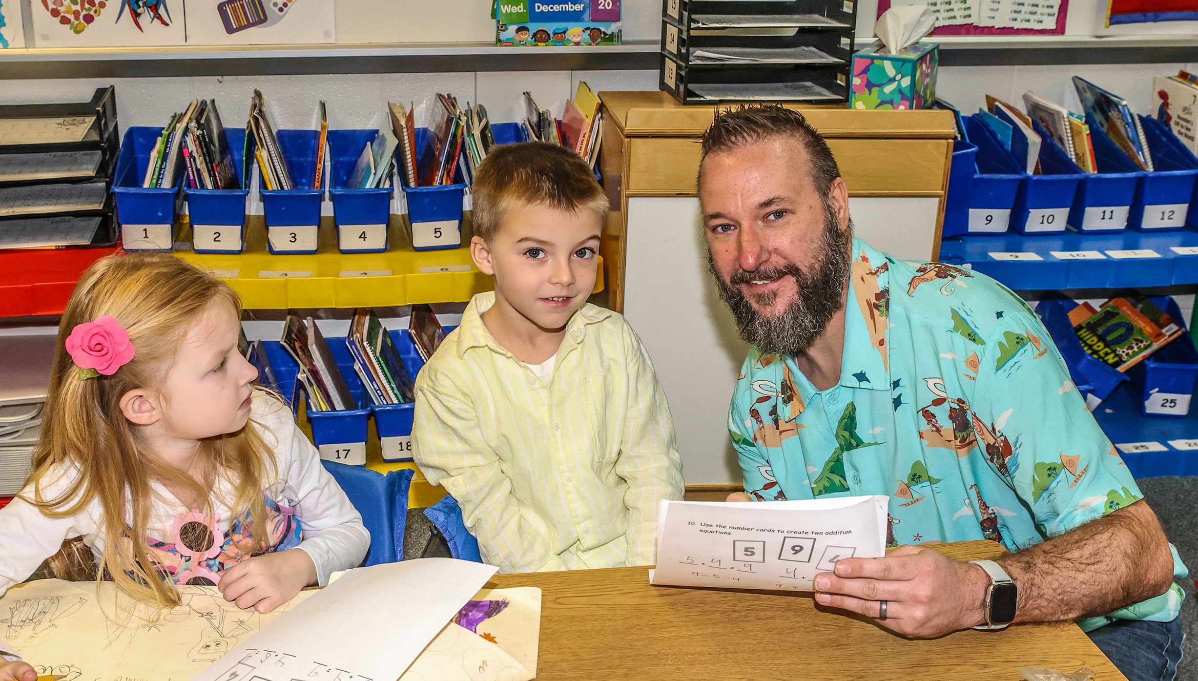 teacher with two students at desk