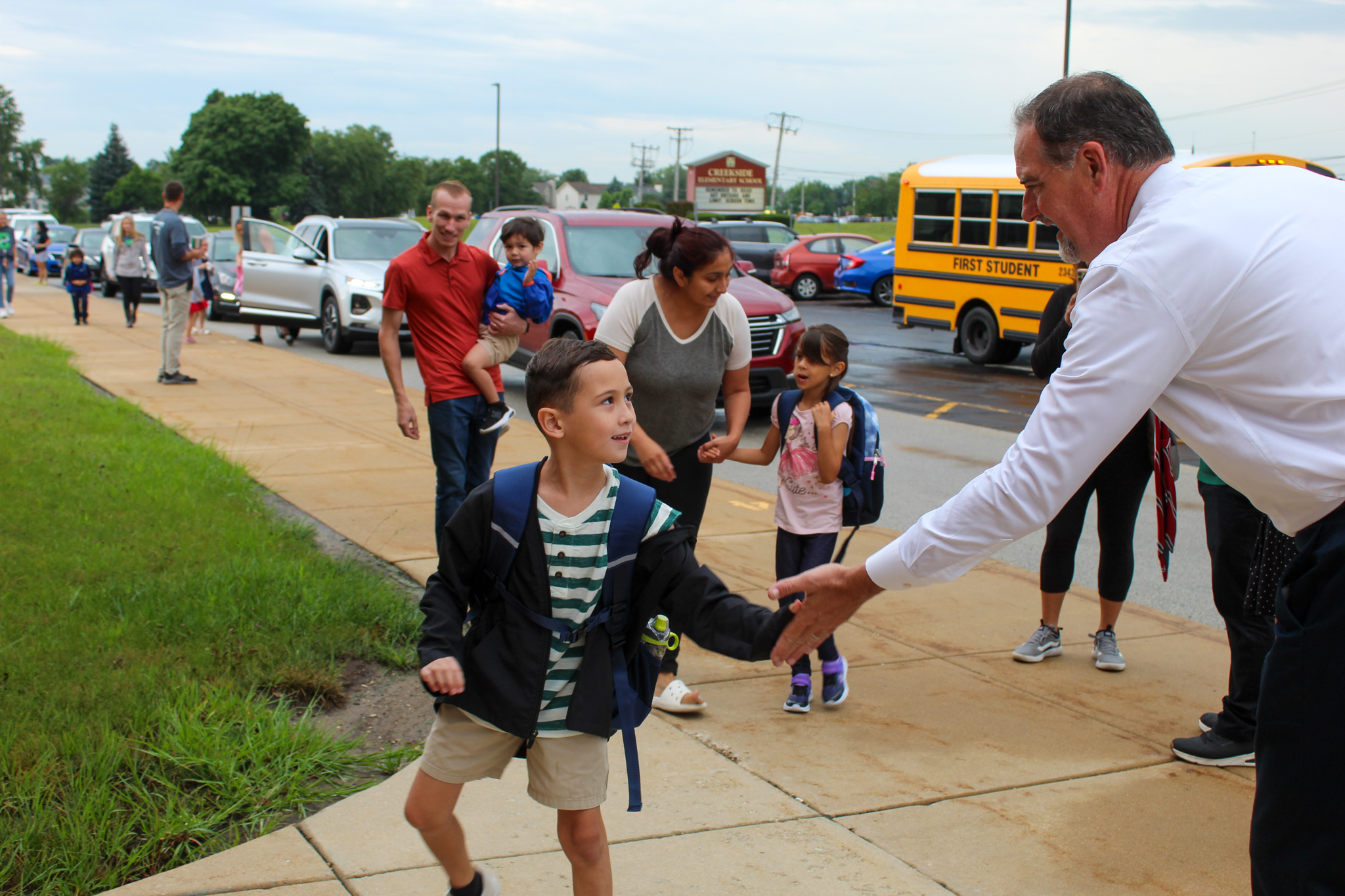 Student gives Dr. Glenn Wood a high five