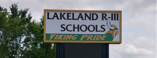 photo of Lakeland R-III Schools sign  outdoors. With yellow and green  Vikings logo 