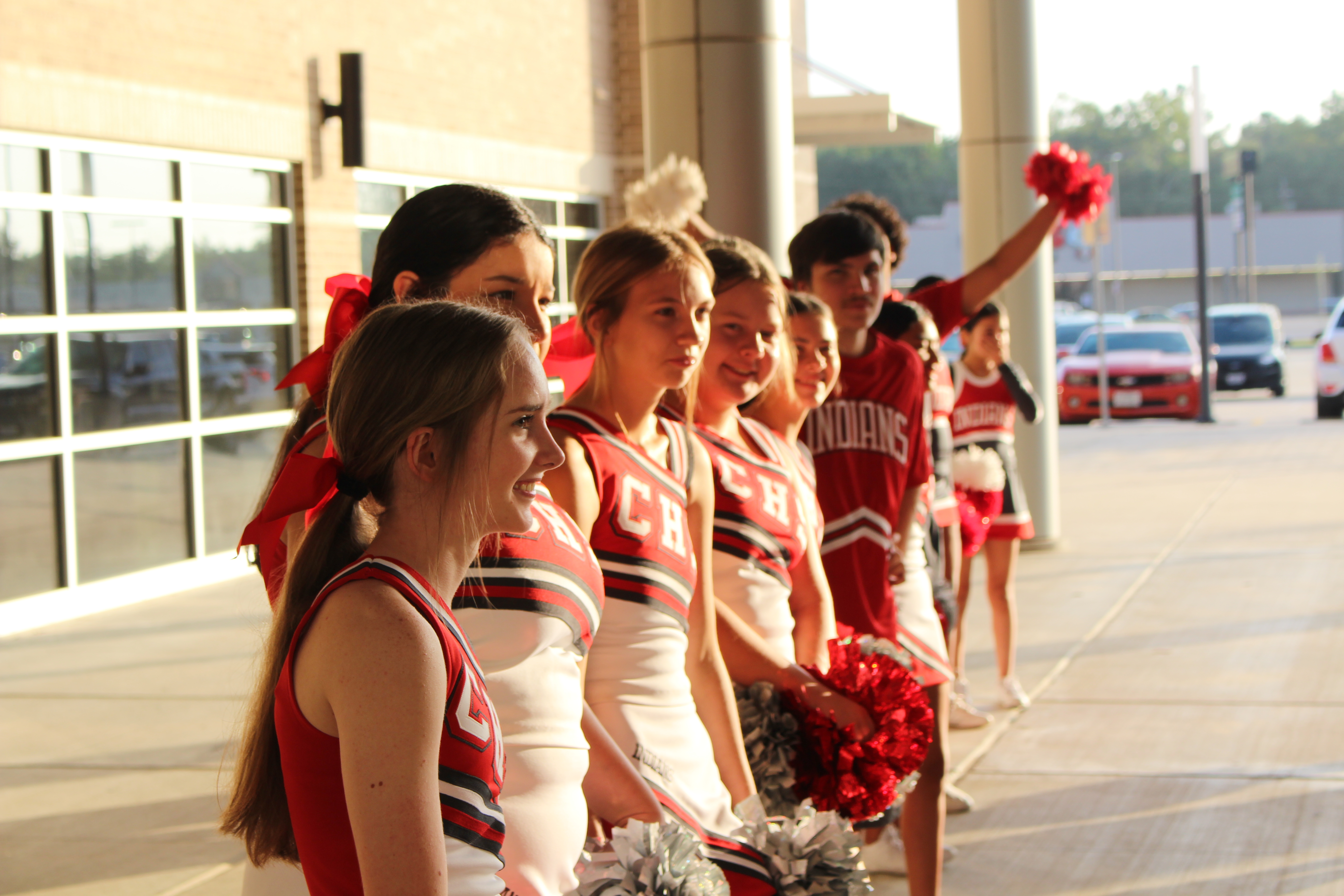 CHS Cheerleaders stand outside the front doors of the cafeteria to welcome in attendees for Convocation 2023