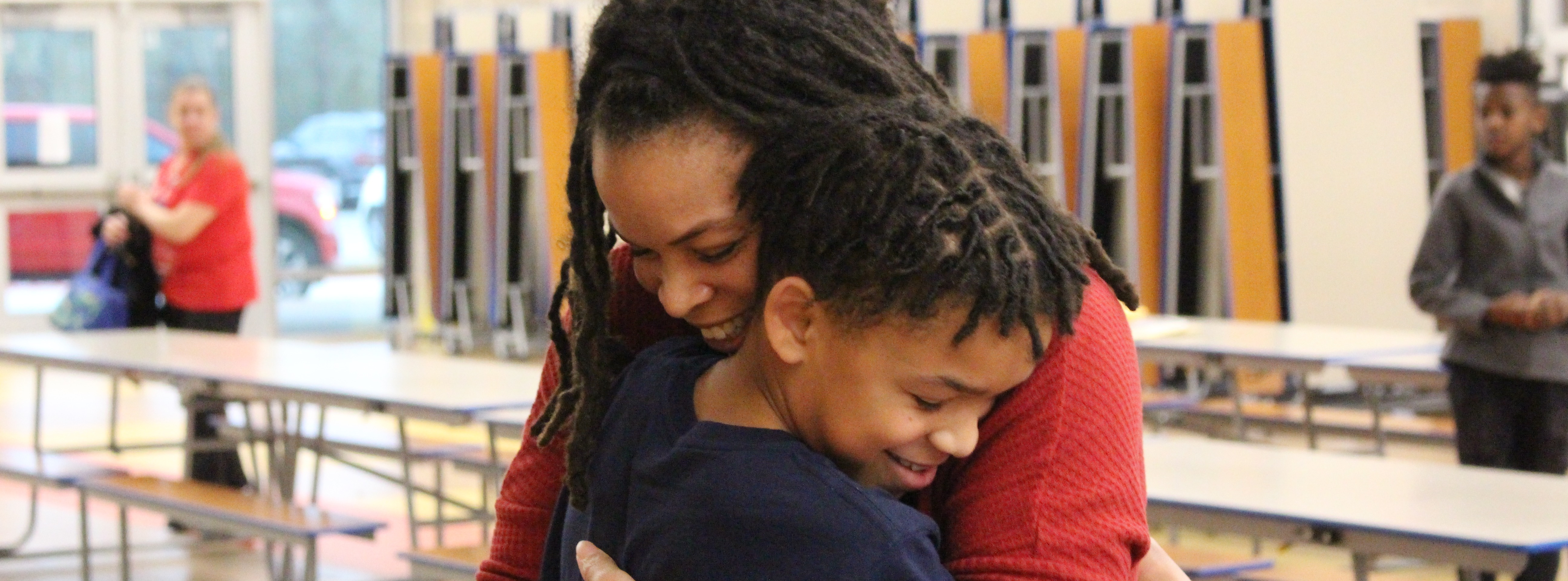Spelling Bee winner at Northside hugging his mother after winning
