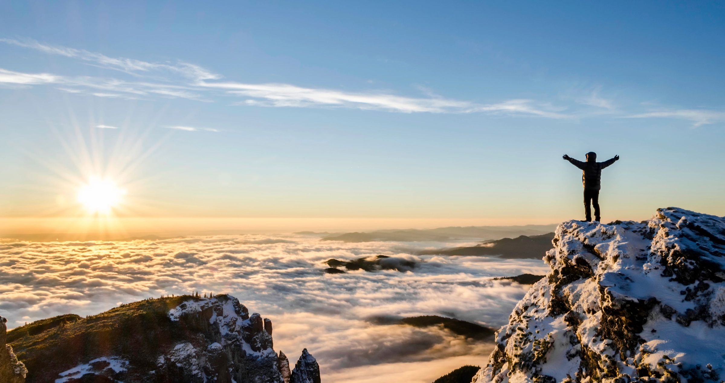 Person at the peak of a mountain