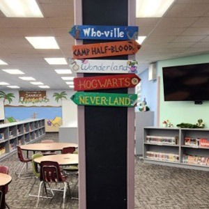 Library direction sign for Who-ville, Camp Half Blood, Wonderland, Hogwarts and Never-Land