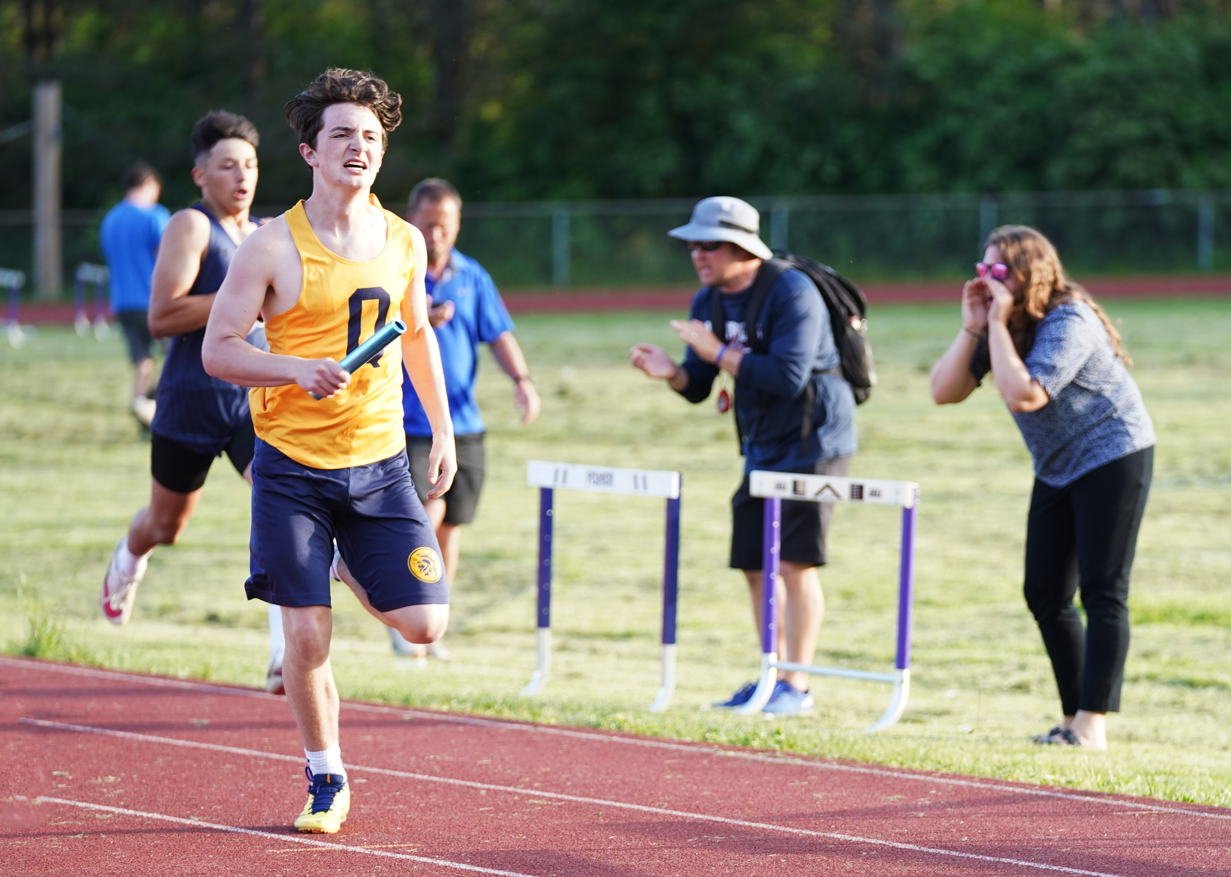 Teen runs in track race.